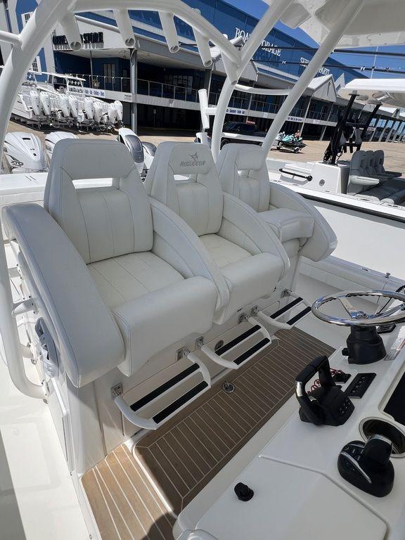 2021 Regulator 41 boat with white captain's chairs and modern helm controls.
