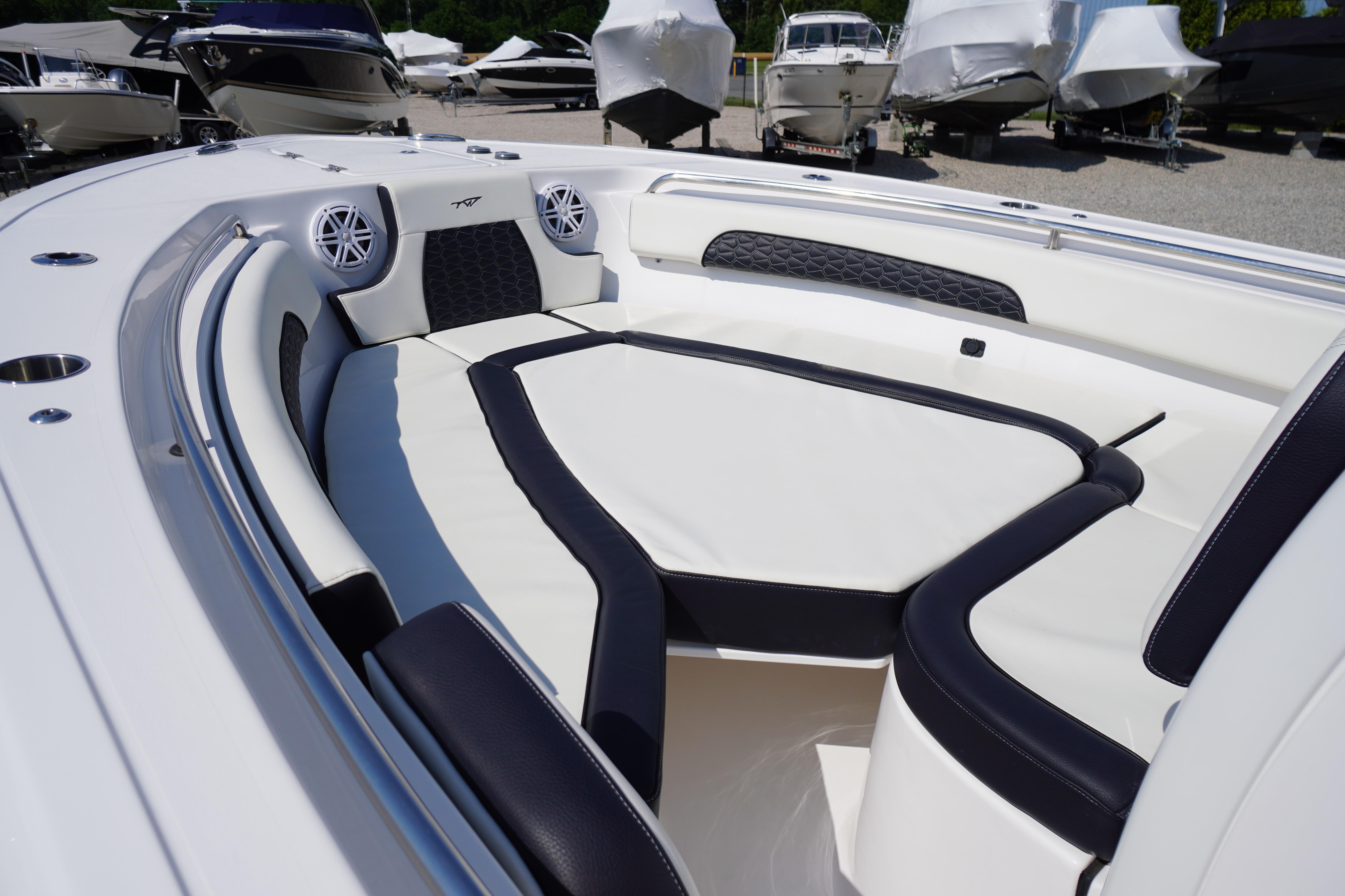 2025 Tidewater 232 SS boat interior with cushioned seating and speakers.