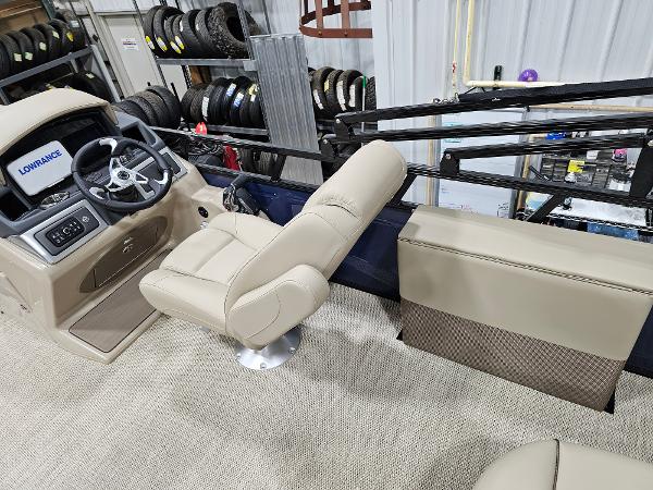 2024 Regency 250 DL3 boat interior with beige captain's chair and steering console.