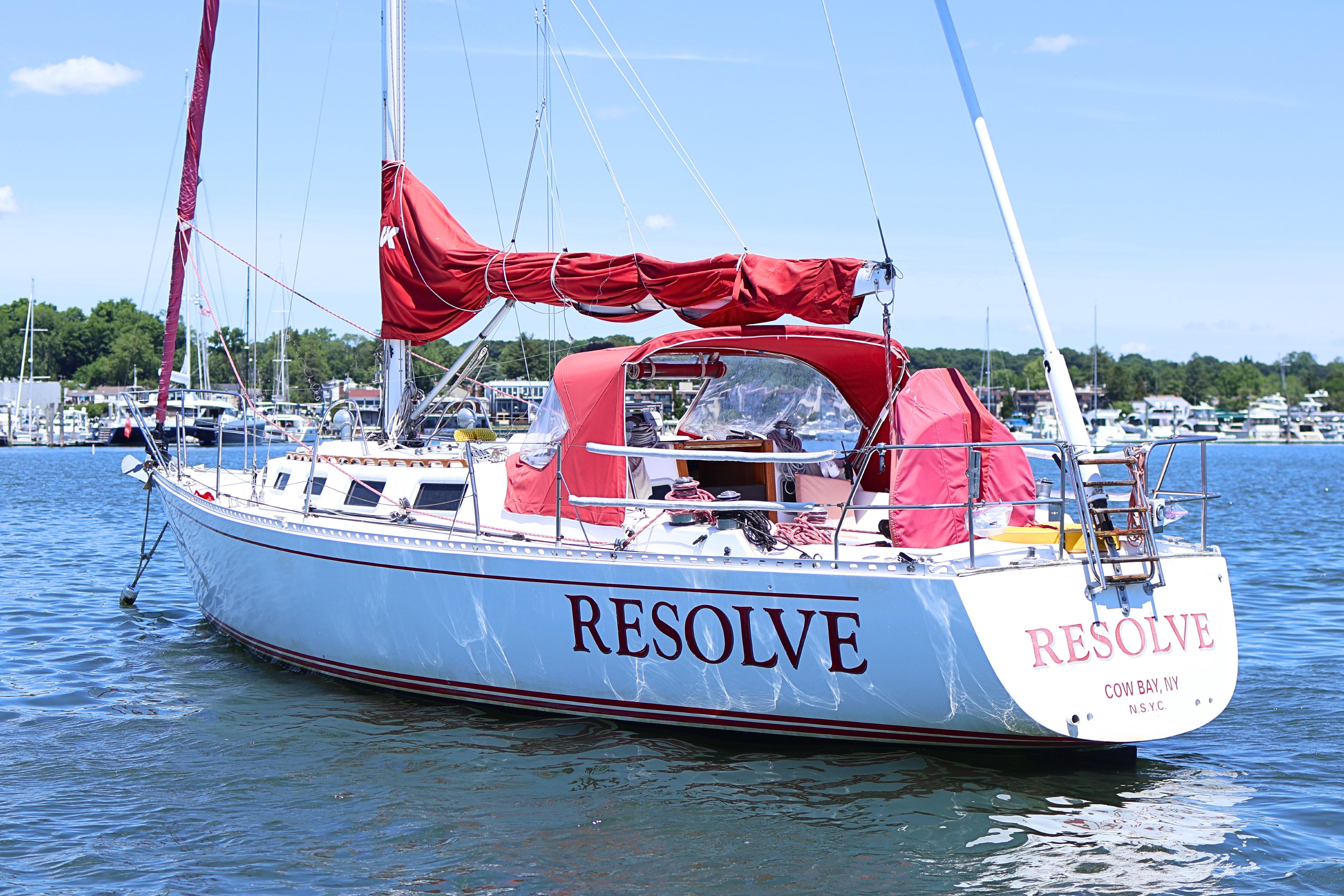 Sailboat "Resolve," a 1989 J Boat J 40, docked in a marina under clear skies.