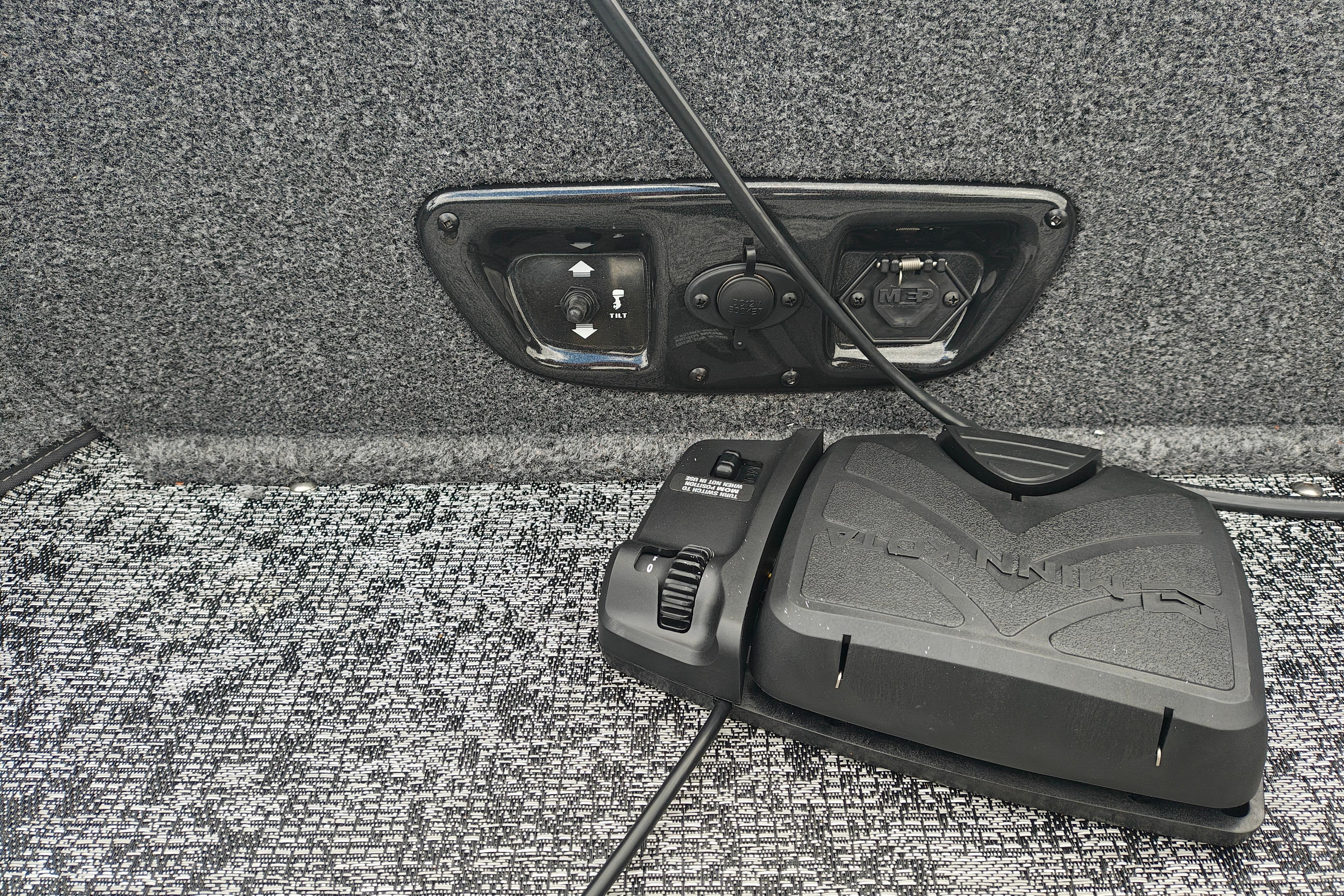 2026 Tracker Pro Guide V-175 WT boat control panel with foot pedal on carpeted floor.