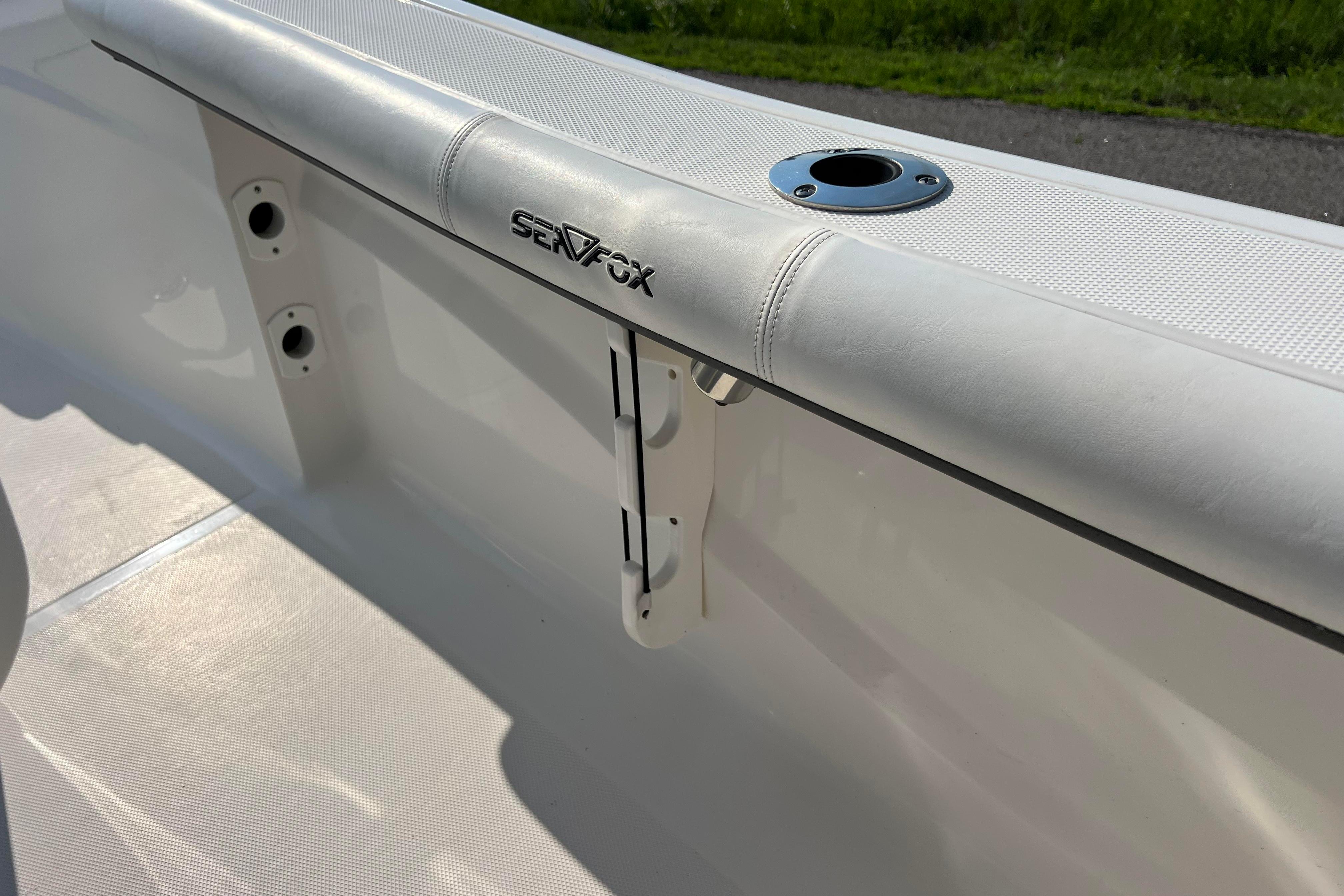 2012 Sea Fox 206 Center Console boat interior with rod holder and padded railing.
