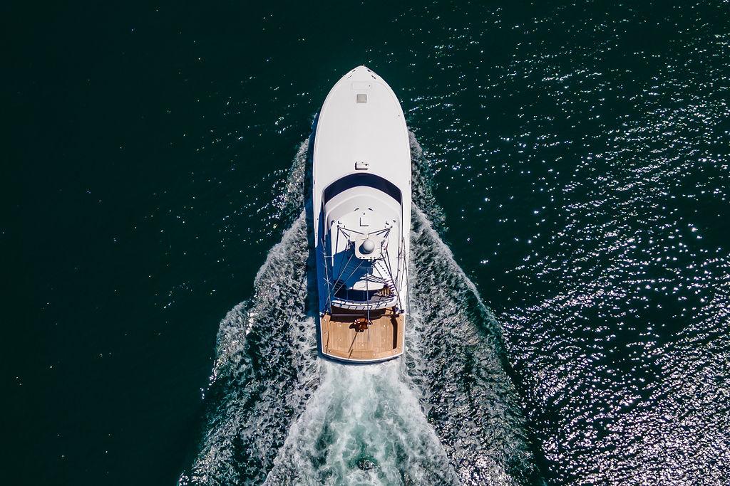 Aerial view of 2014 Hatteras 63 GT yacht cruising on open water.