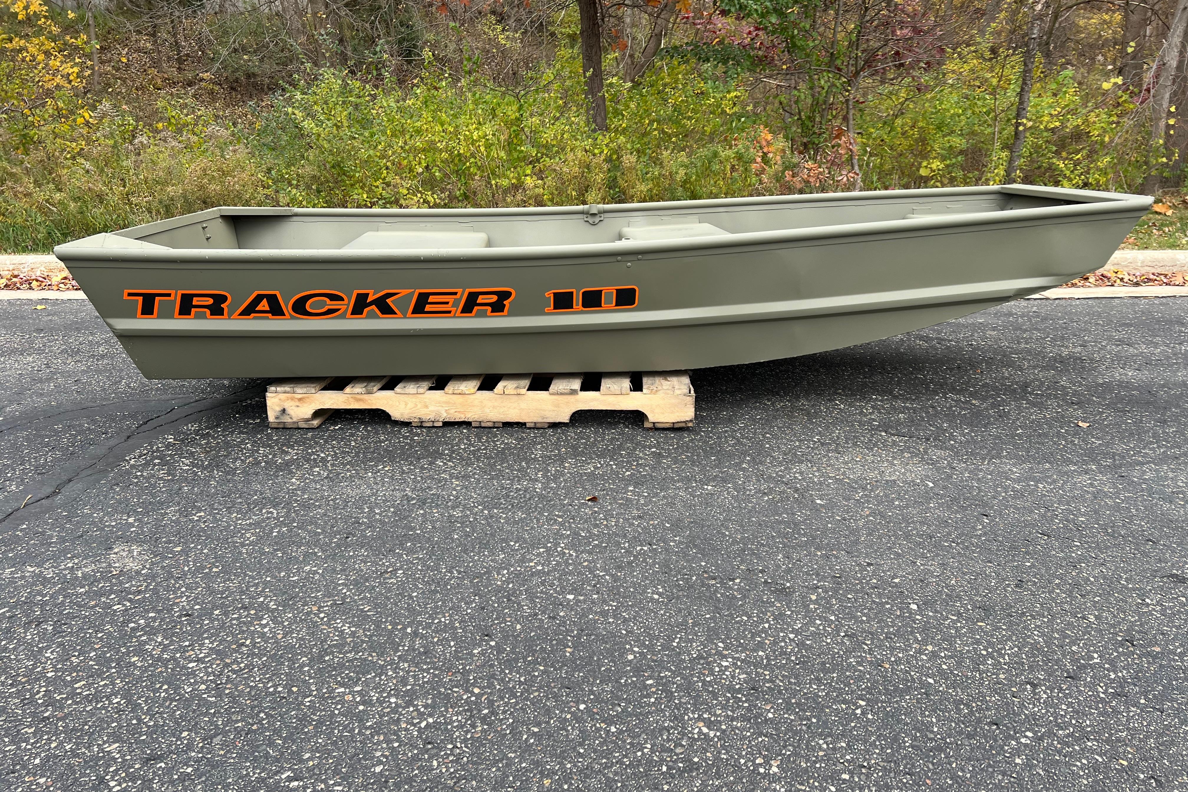 2026 Tracker Grizzly 10 Jon boat on wooden pallet, outdoors.