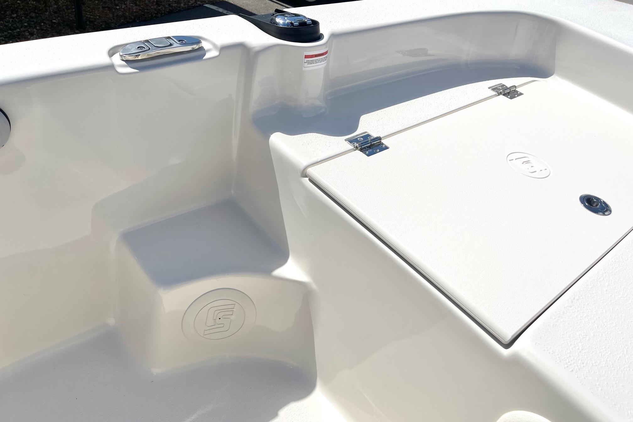 2026 Carolina Skiff 19 LS boat interior, featuring storage compartment and seating area.