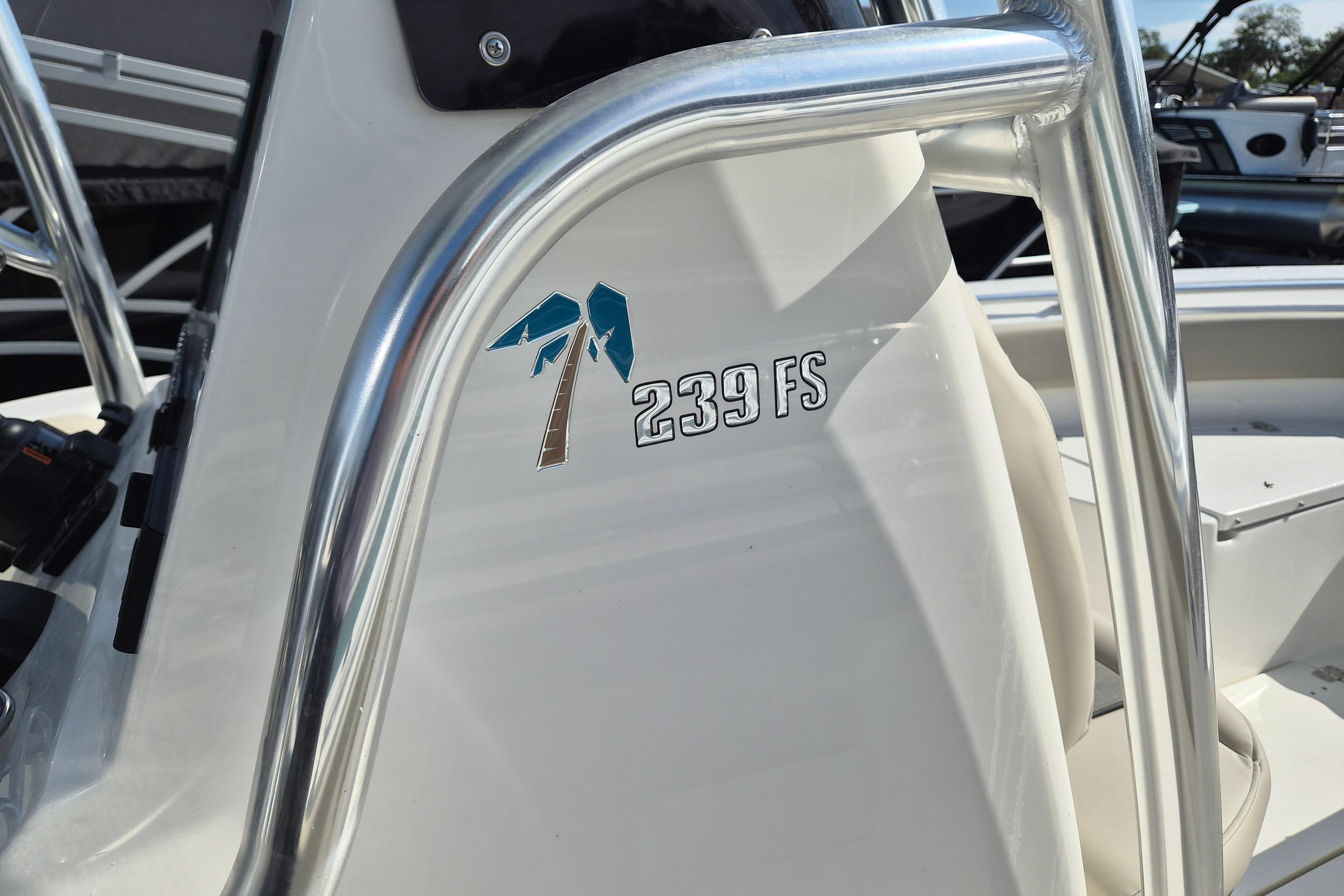 2026 Key West 239 FS boat detail with palm tree logo and stainless steel railing.