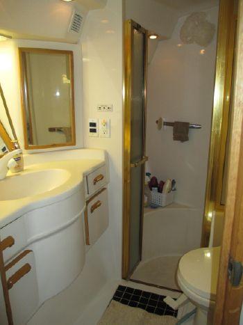 Bathroom interior of 1994 Sea Ray 500 Sundancer yacht, featuring shower and vanity.