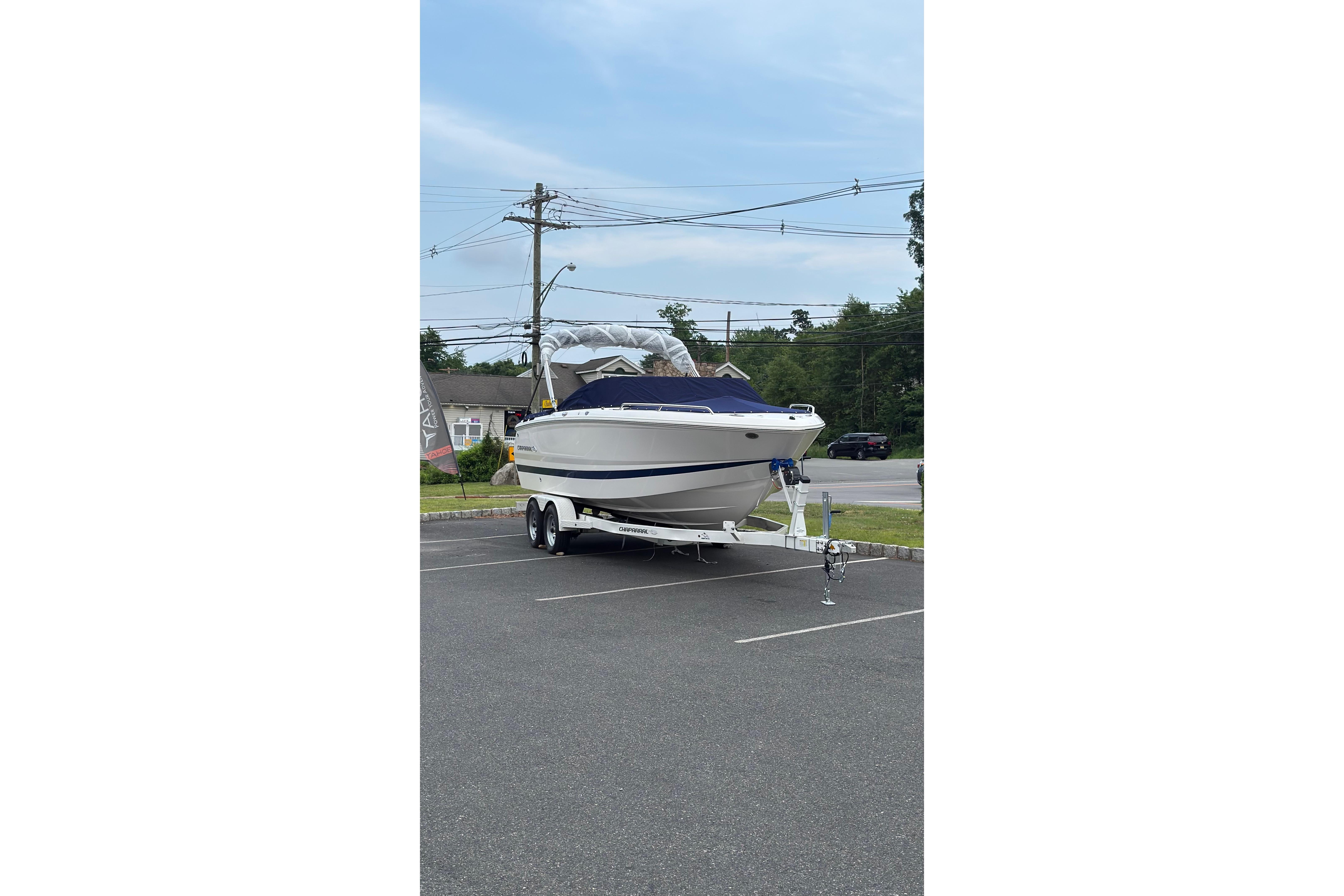 2026 Chaparral SSX 4 boat on trailer in parking lot, clear sky background.
