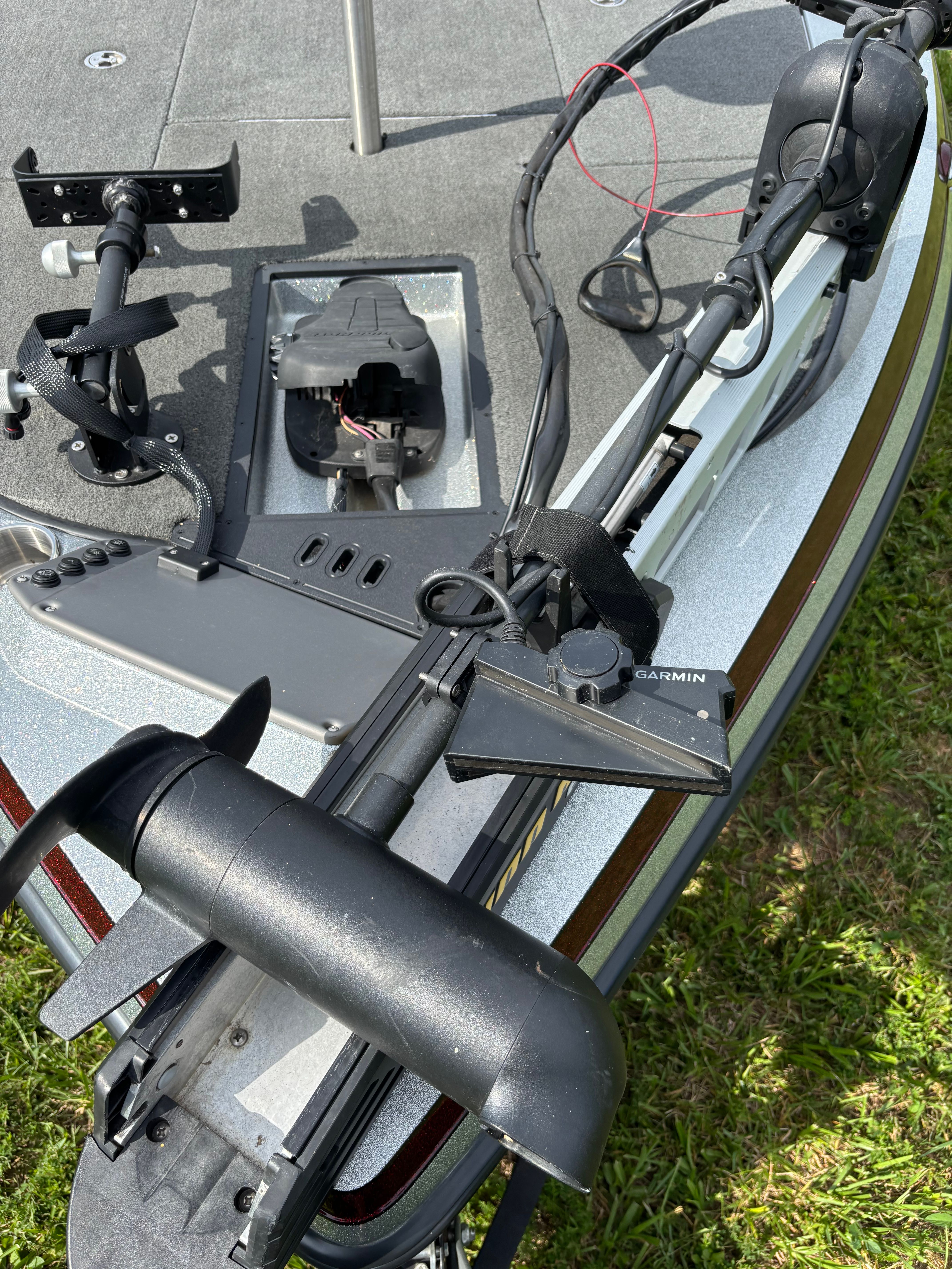 Close-up of a boat deck with fishing gear and electronics.