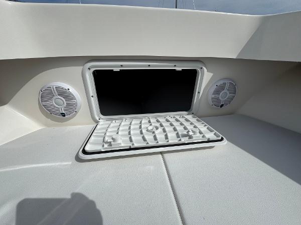 2025 NorthCoast 230 Center Console boat with open storage hatch and speakers.