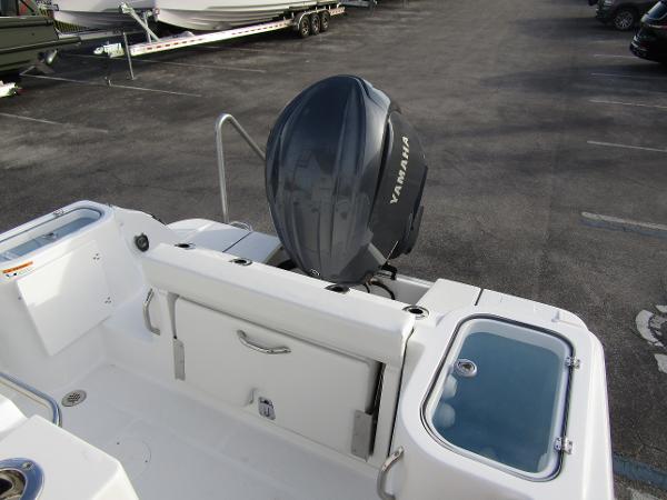 2025 Wellcraft 243 Fisherman boat with Yamaha outboard motor, docked in a parking area.