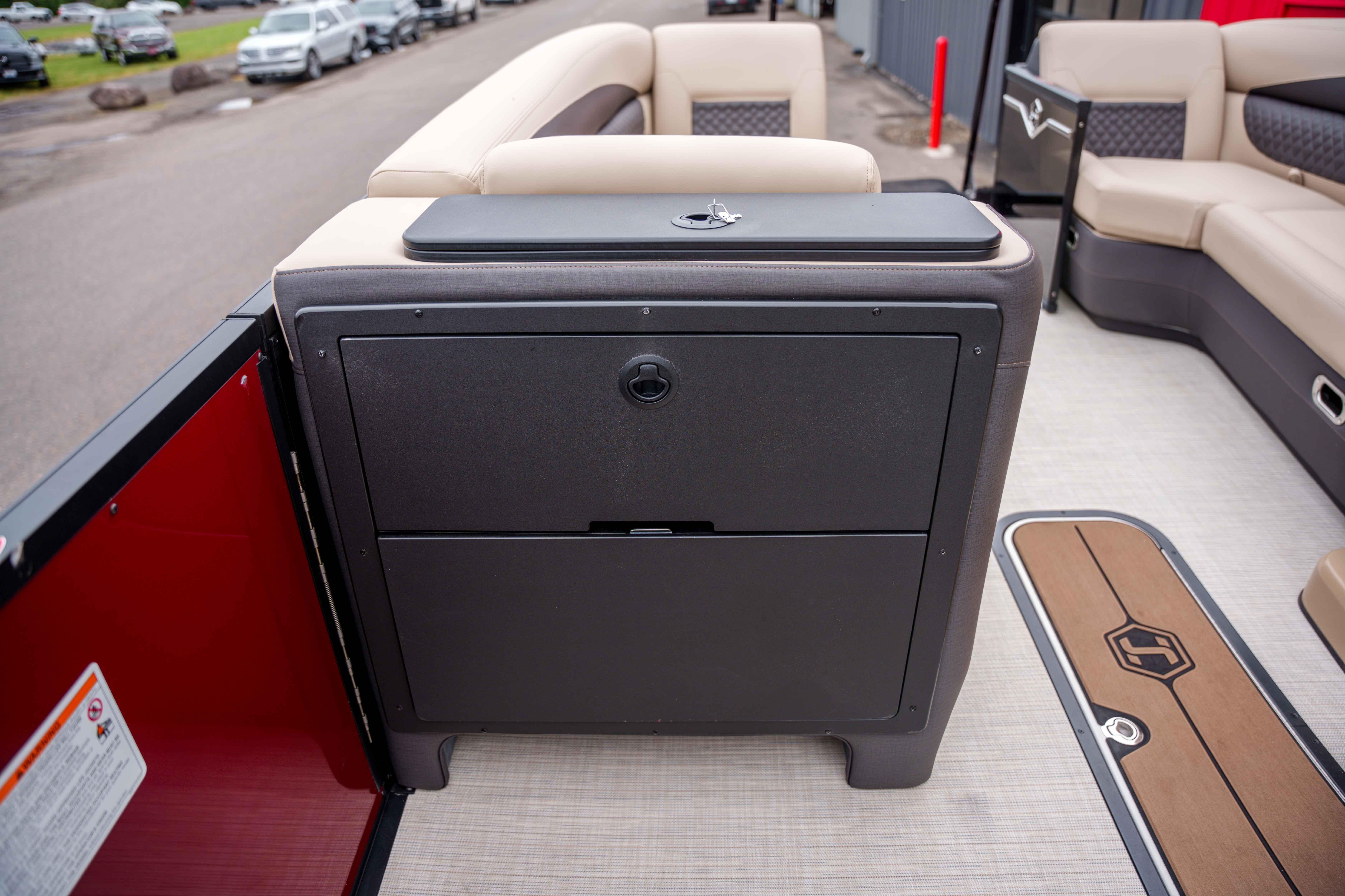 2026 Harris Sunliner 230 interior with seating and storage compartment.