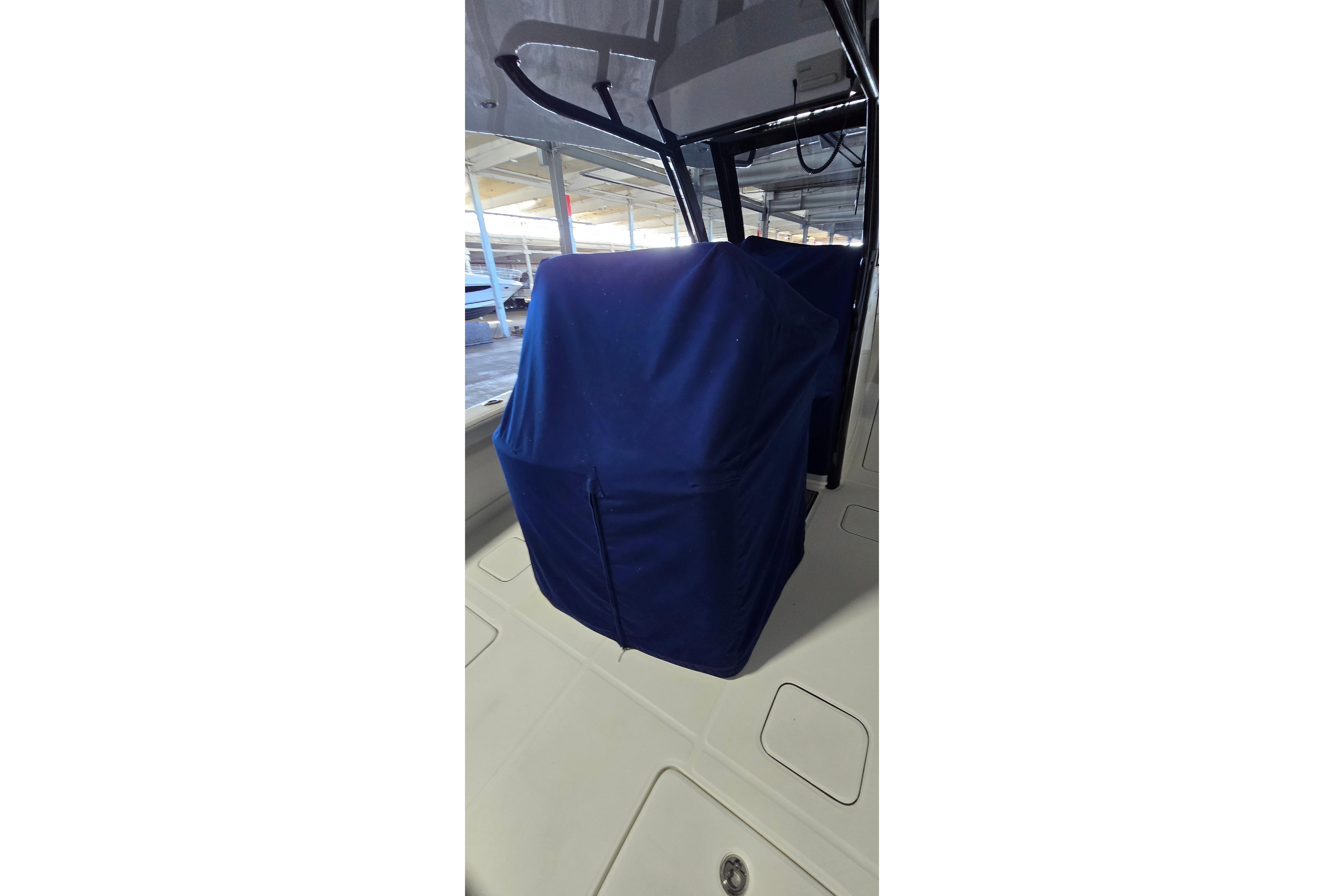 2024 WorldCat 280 CC-X boat interior with blue cover, showcasing console area.