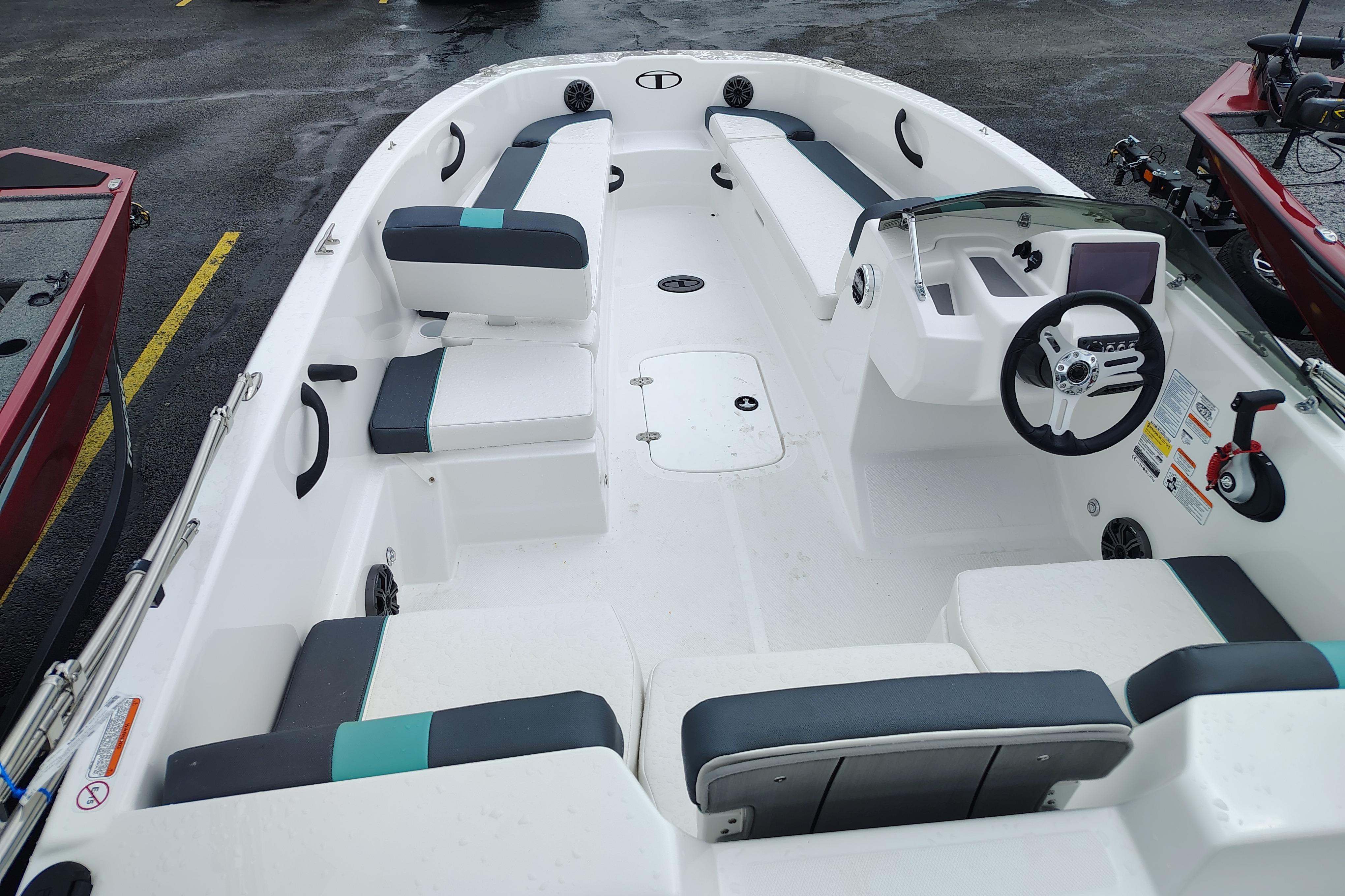 2026 Tahoe T18 boat interior with seating, steering wheel, and control panel.
