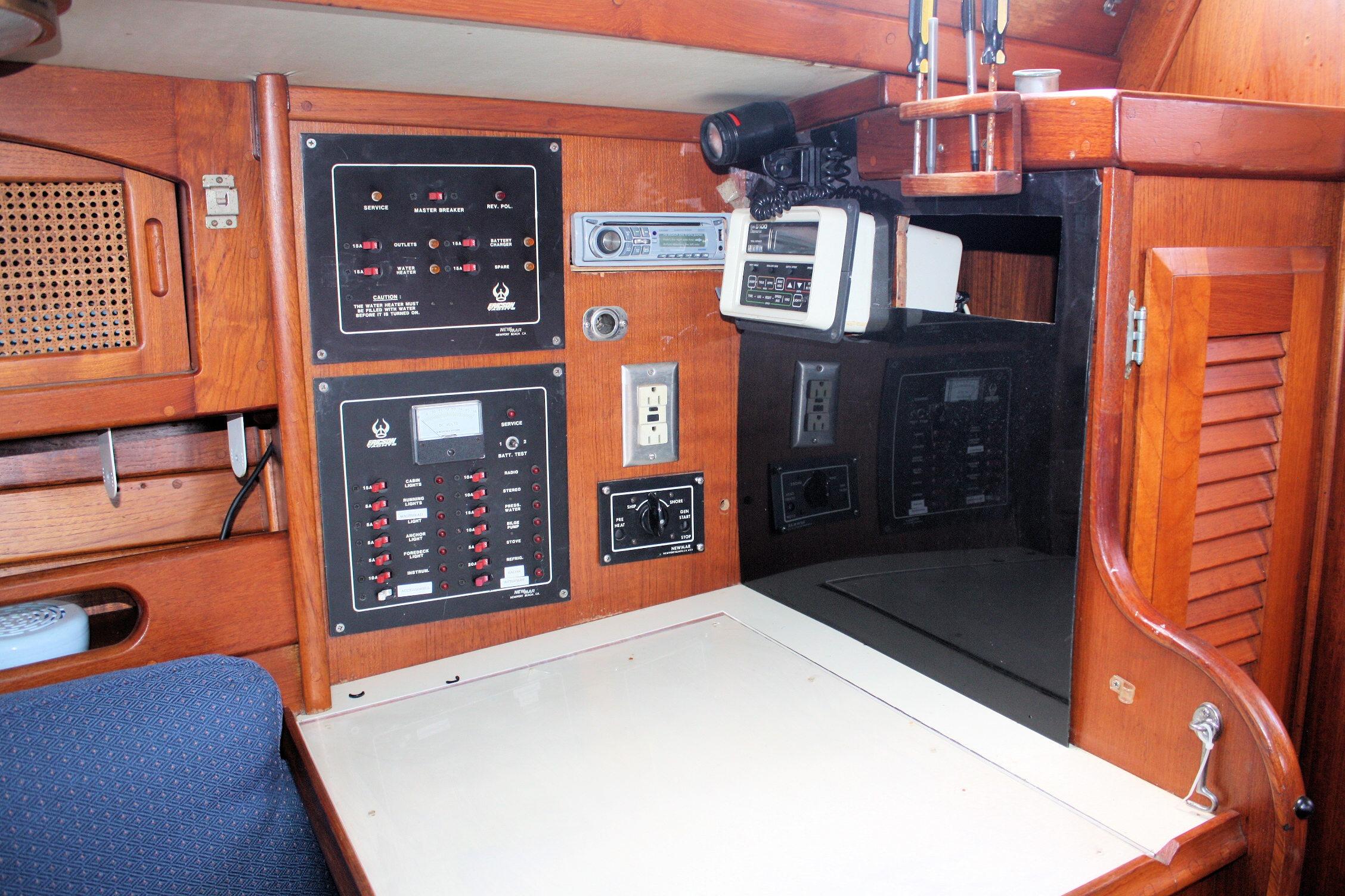 Navigation station of a 1987 Ericson 38-200 sailboat with control panels and equipment.