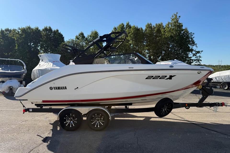 2026 Yamaha Boats 222XD on trailer, parked outdoors with trees in background.