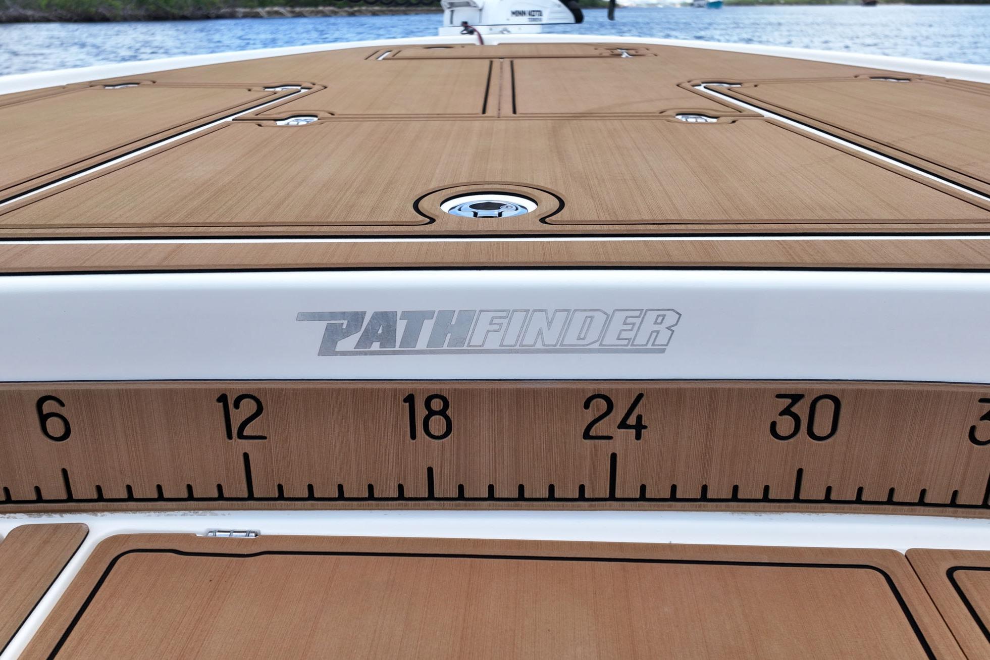 2017 Maverick Boats Pathfinder deck with measurement markings, featuring sleek wood finish.