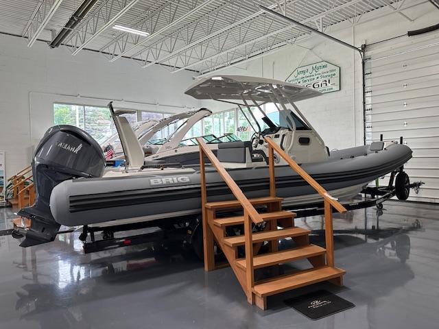 2025 Brig Eagle 8 boat displayed indoors with wooden steps and Yamaha engine.