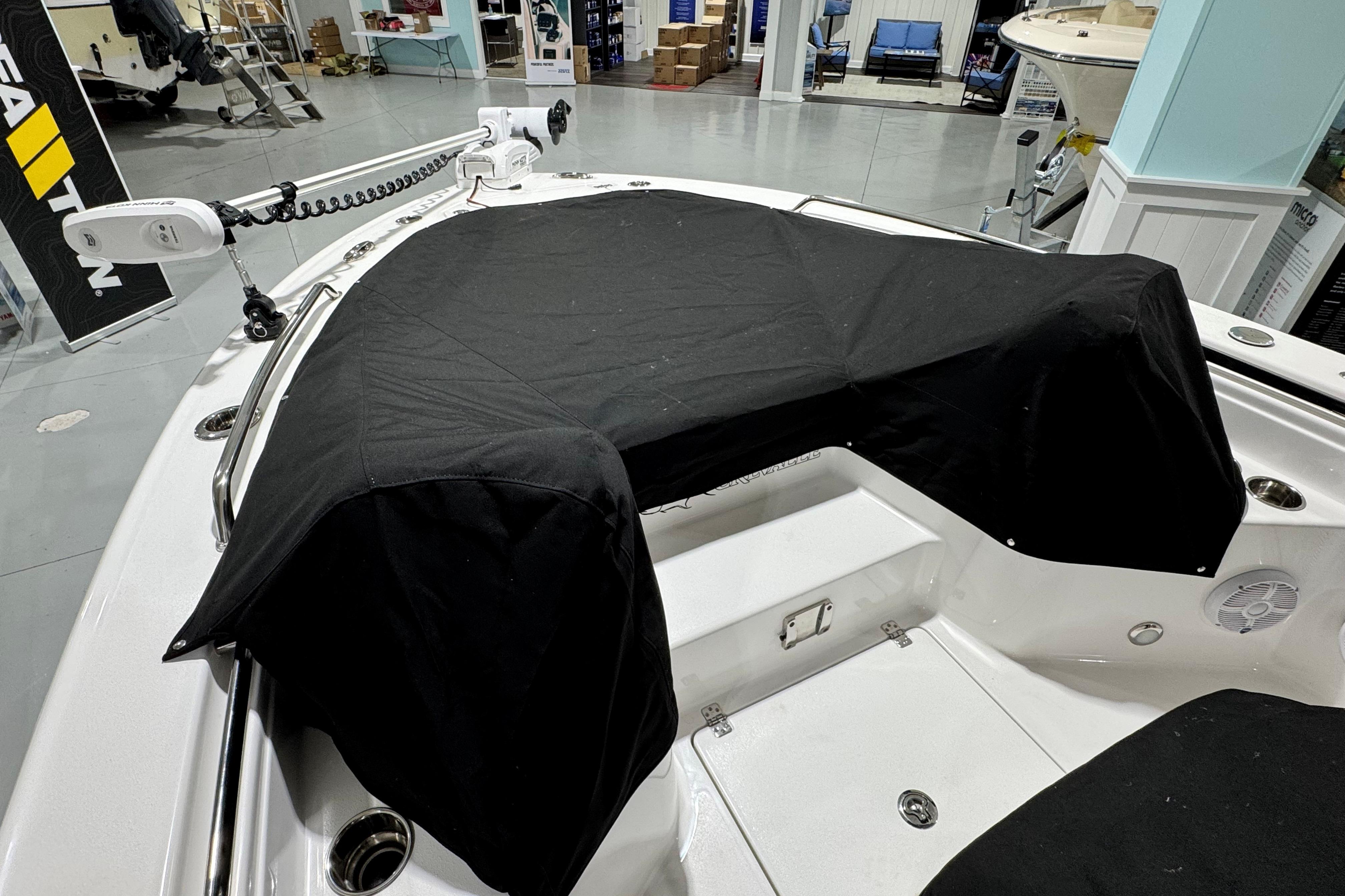 2025 Crevalle 24 HCO boat interior with black cover, showcasing modern design and equipment.