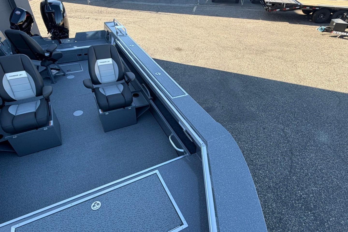 Interior view of 2026 Thunder Jet 209 Rush OT boat with seating and motor.