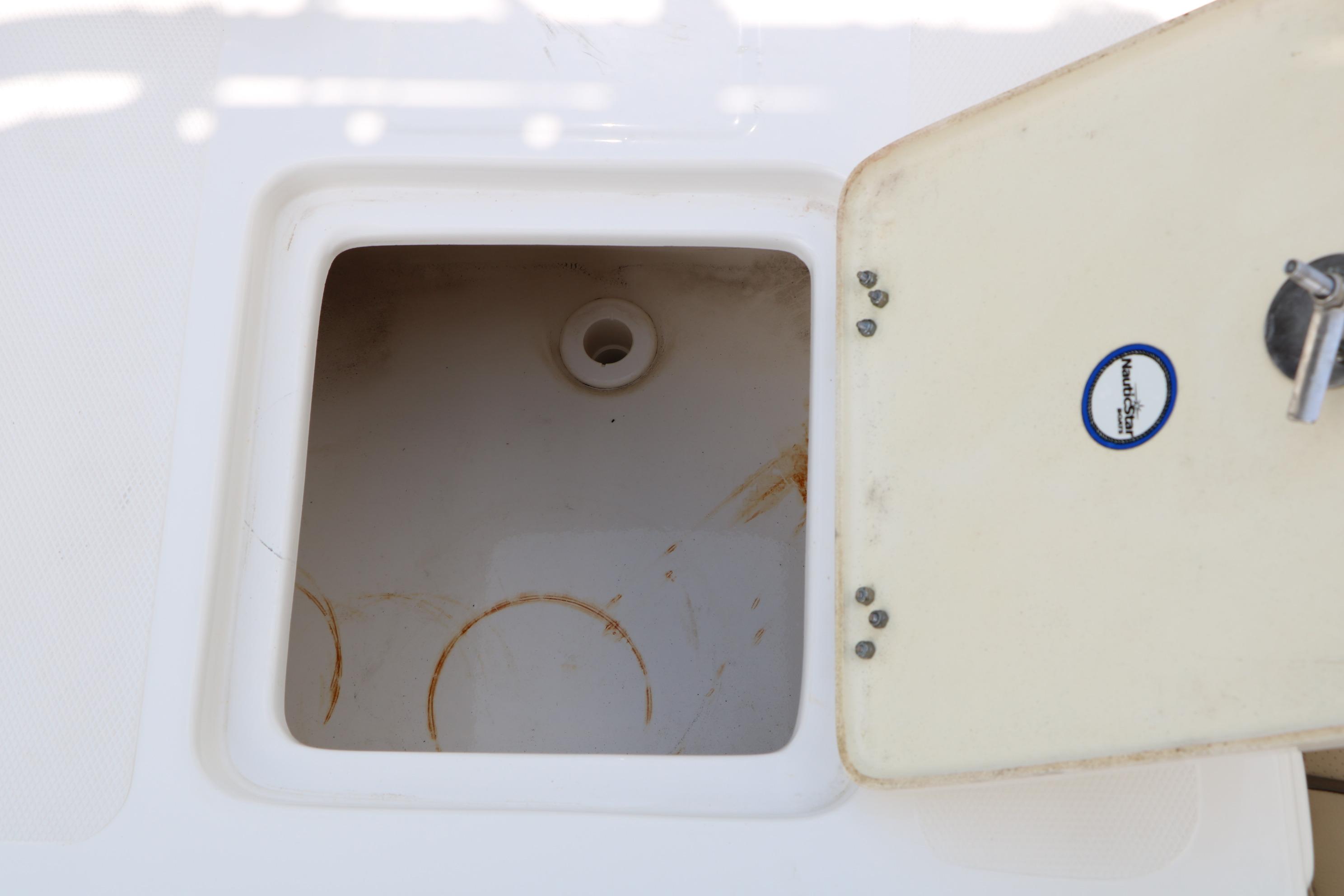 Open storage compartment on 2020 NauticStar 2140 Sport boat.
