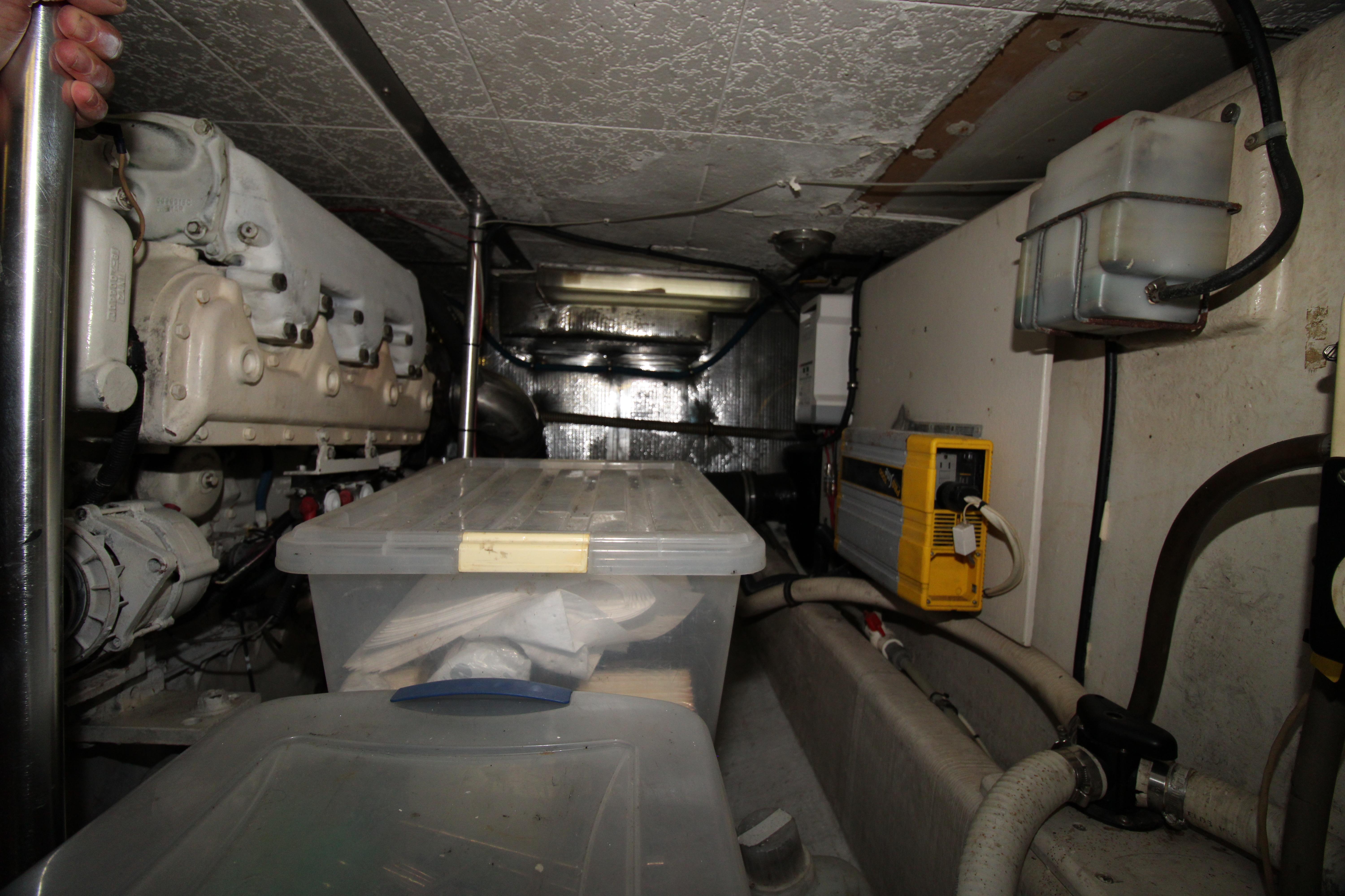 Engine room of 2000 Ricker 42 Classic boat with storage containers and equipment.
