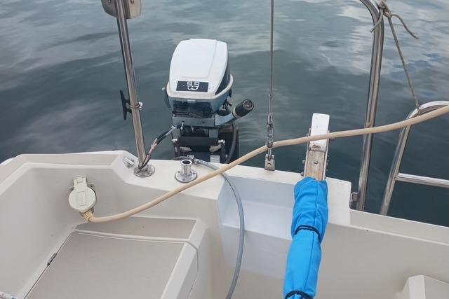 1989 O'Day 272 sailboat with outboard motor on calm water.