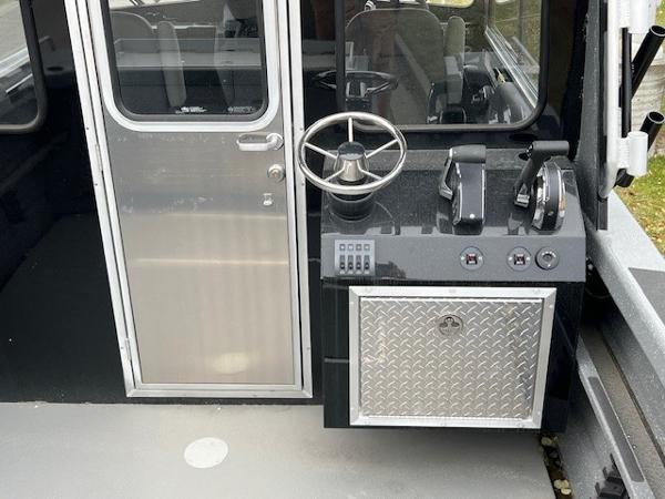2024 Spartan 220 Maximus boat cockpit with steering wheel and control panel.