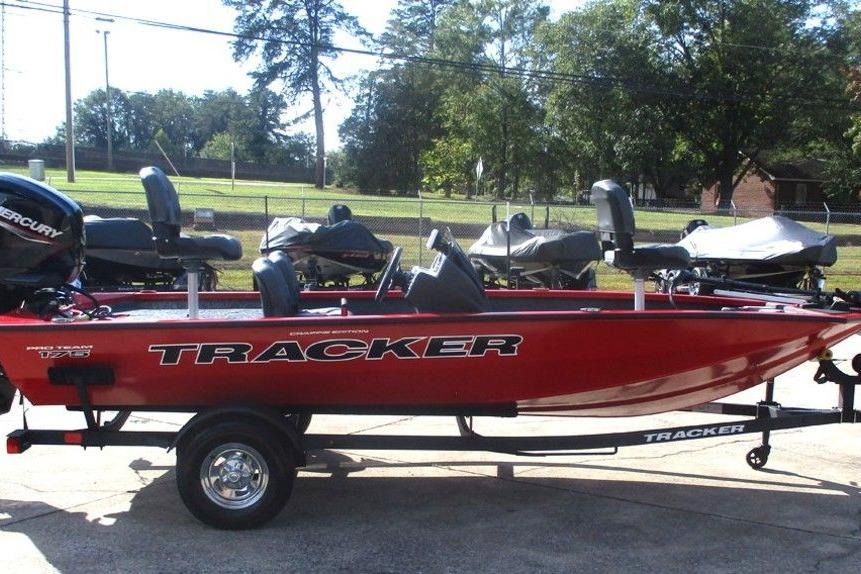 2026 Tracker Pro Team 175 boat in vibrant red, parked outdoors on a trailer.
