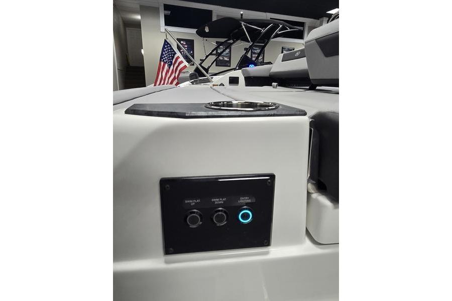 2026 Cobalt R31 boat interior with control panel and American flag.