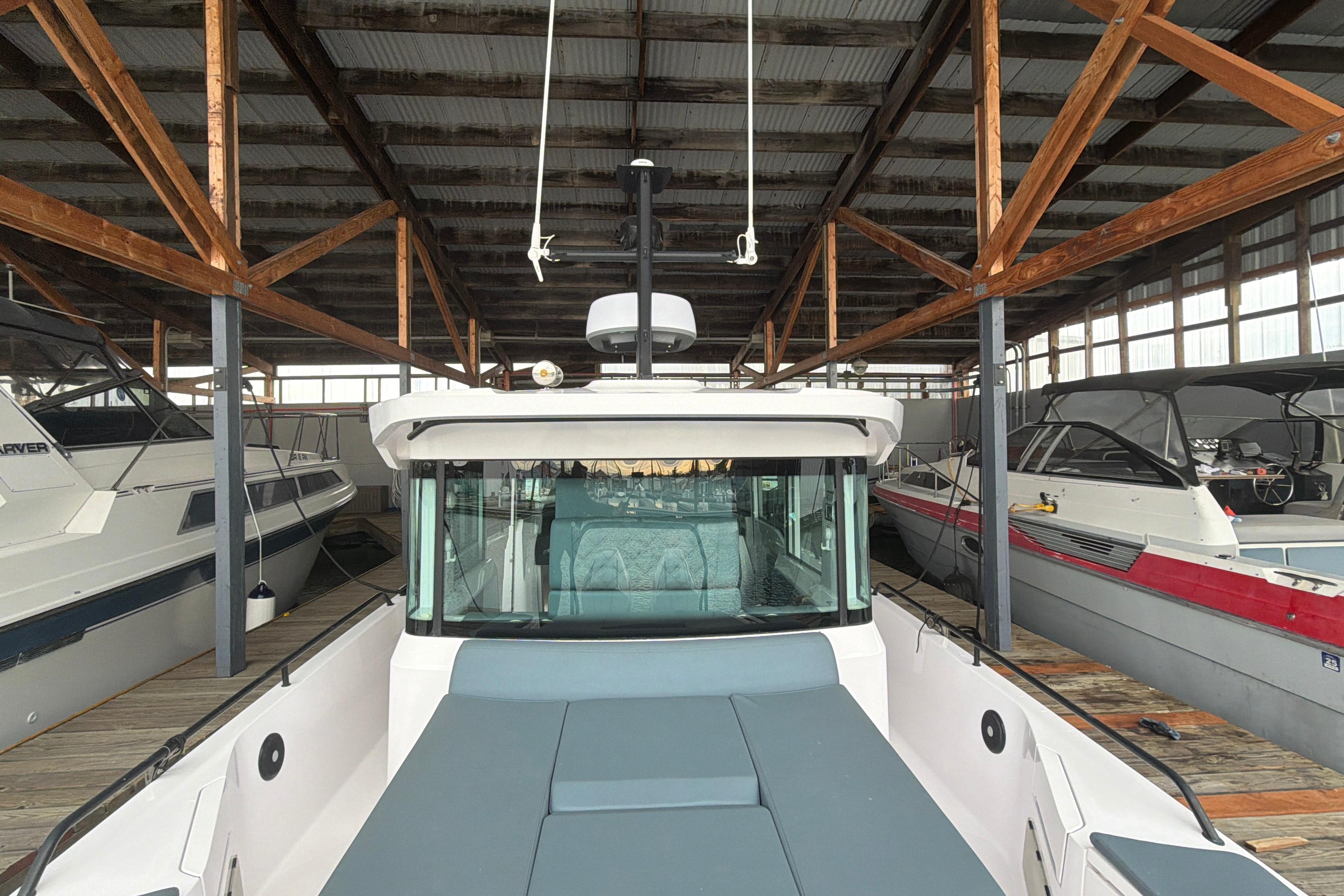 2022 Axopar Brabus 37 XC Cross Cabin docked in a covered marina.