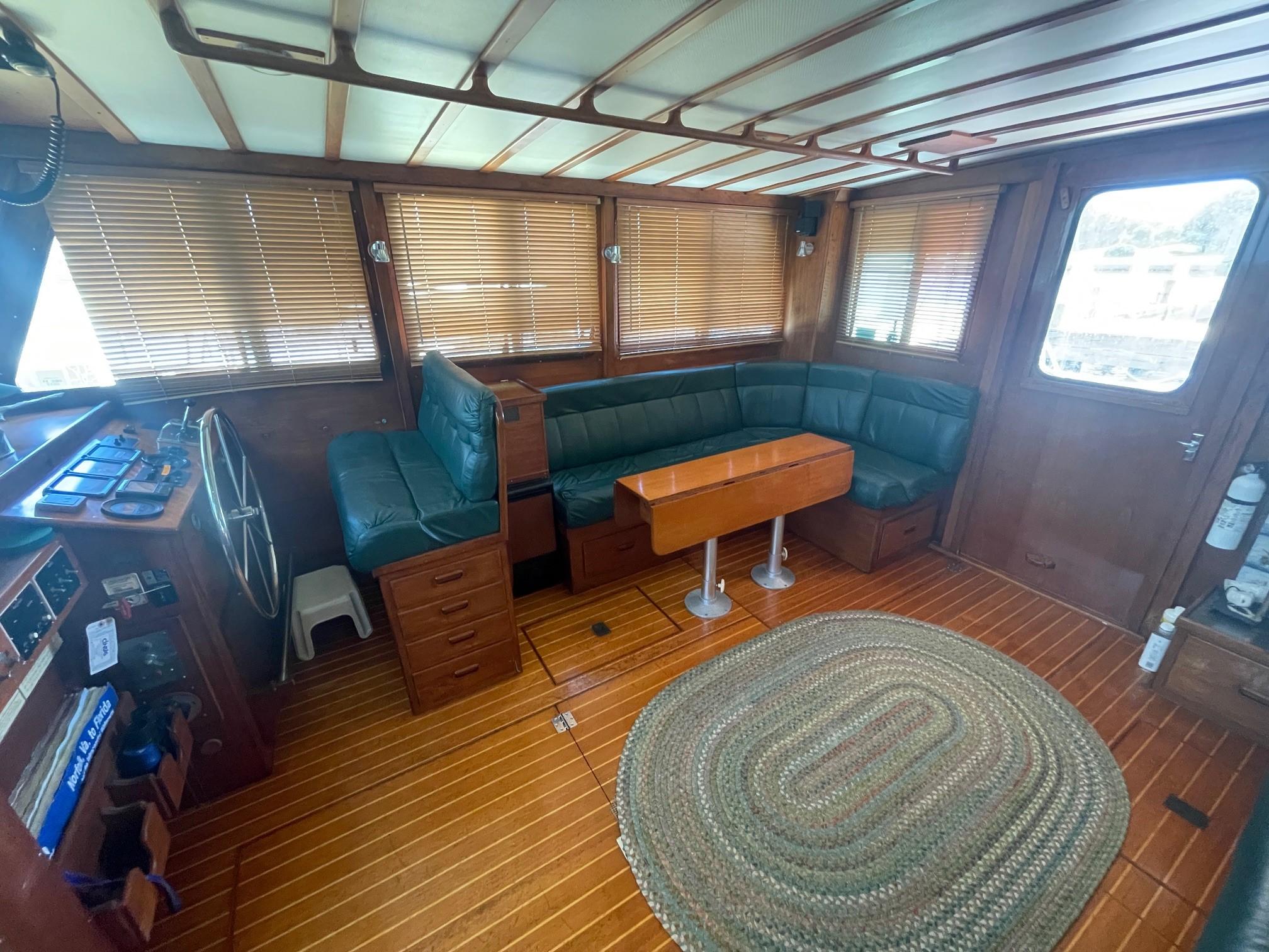 1979 Jarvis Newman Trawler interior with wooden finish and green seating.