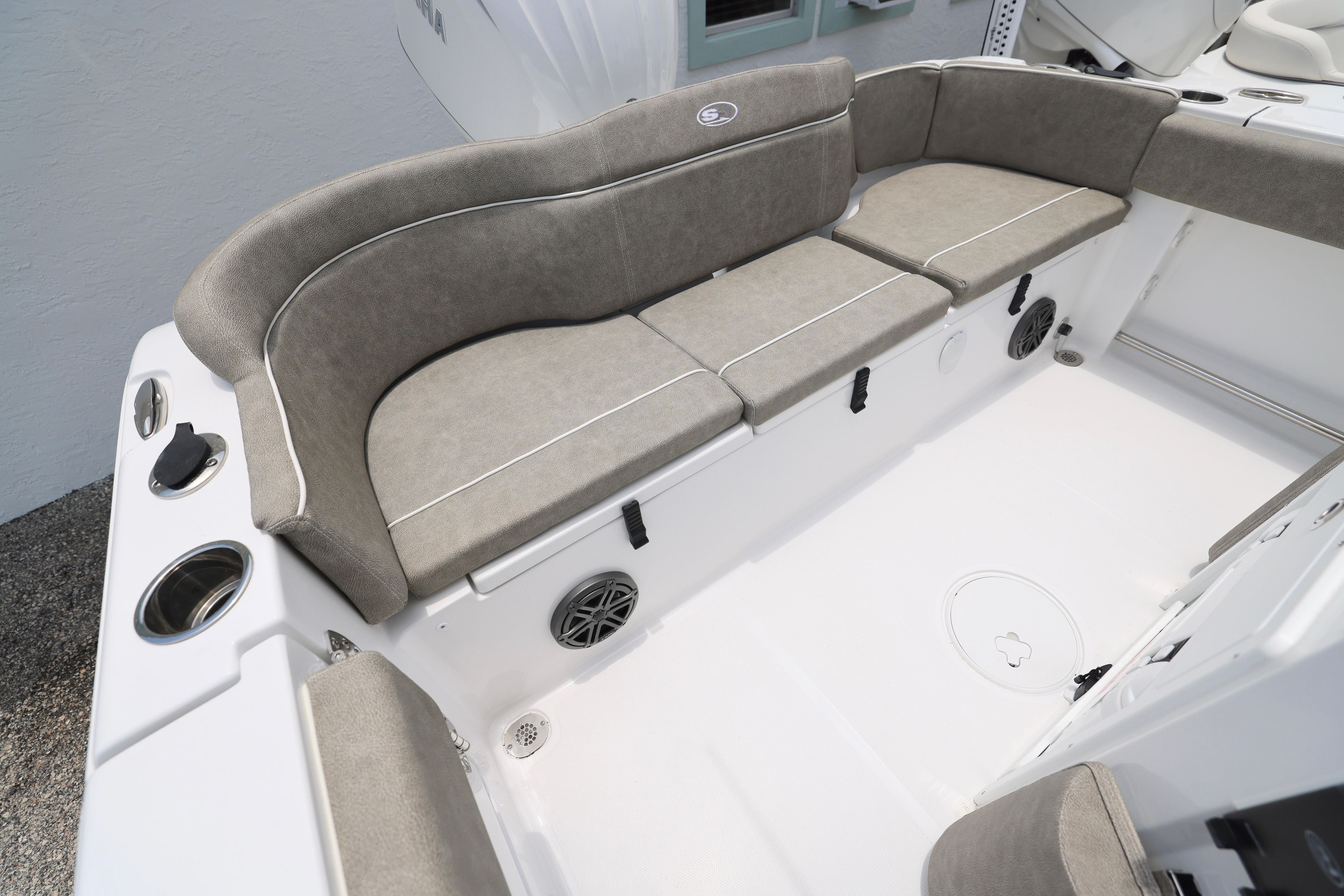 2026 Sea Hunt Ultra 245 SE boat interior with cushioned seating and cup holders.