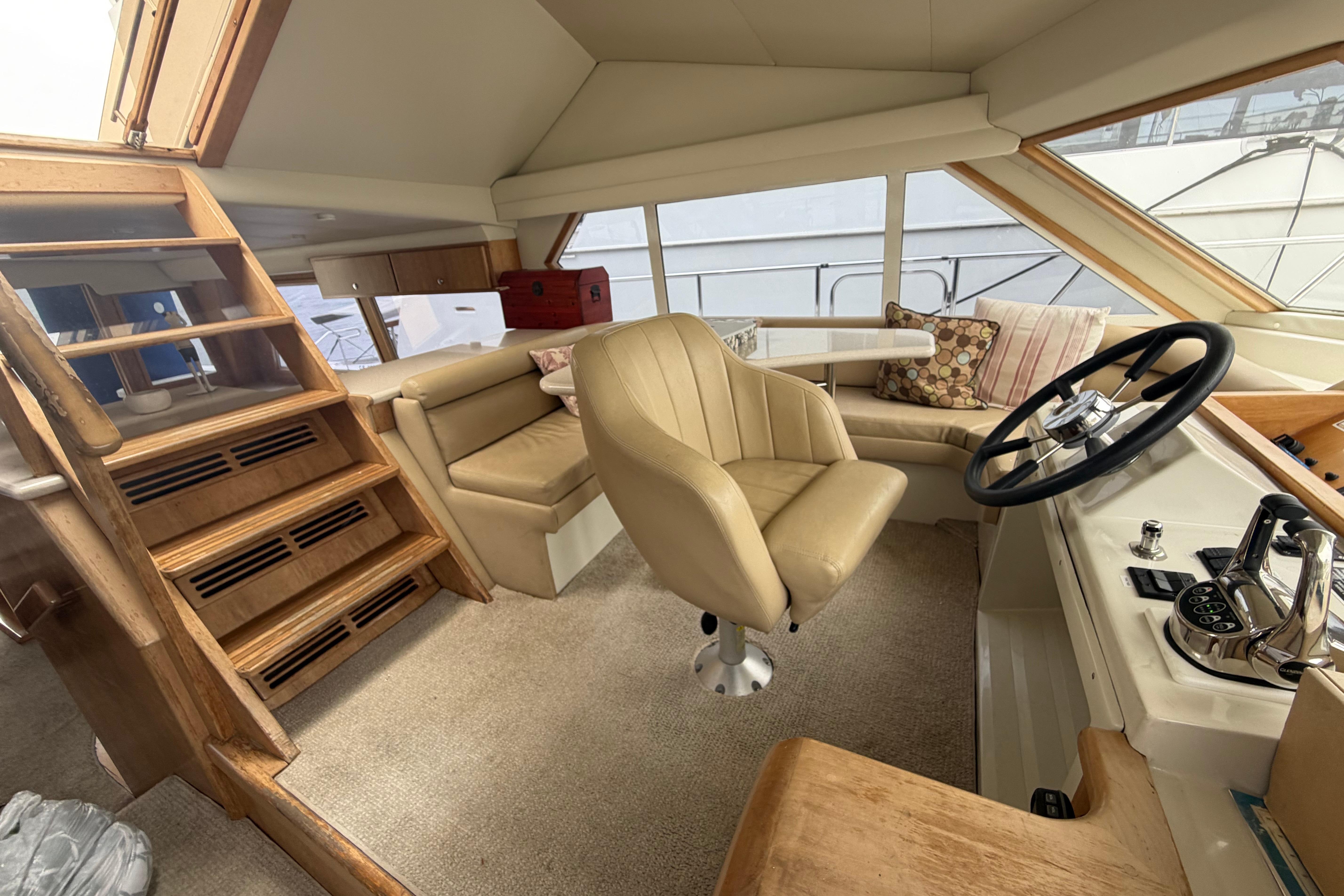 Luxurious interior of 2005 Navigator 53 Pilot House yacht with helm and seating area.