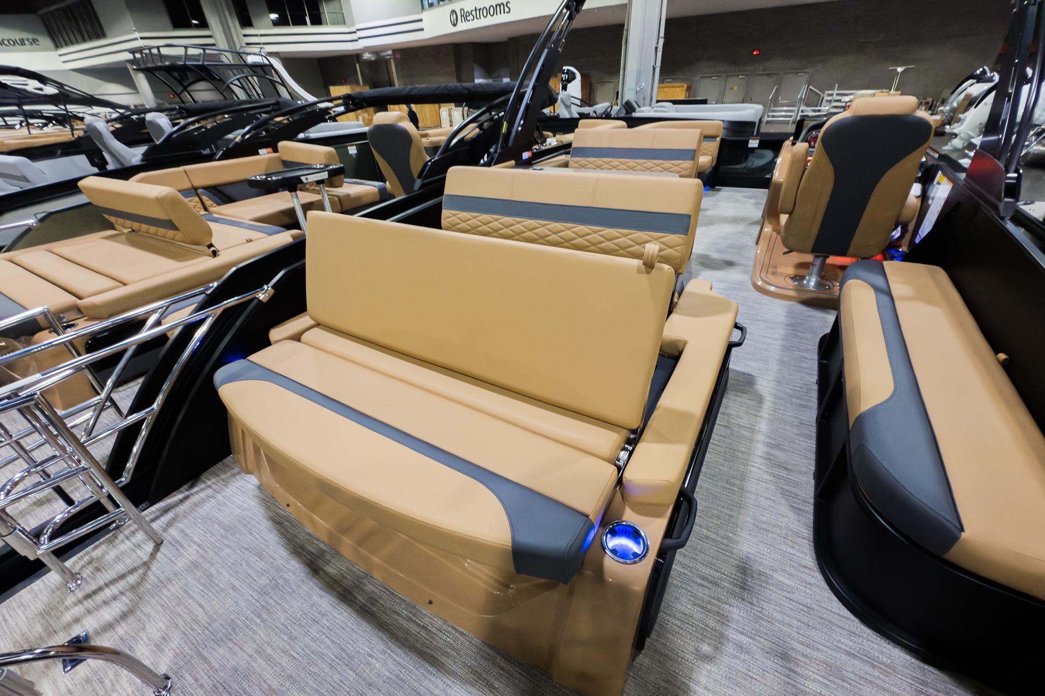 2026 Godfrey Monaco 255 boat interior with tan and gray seating, mid-table lounge.