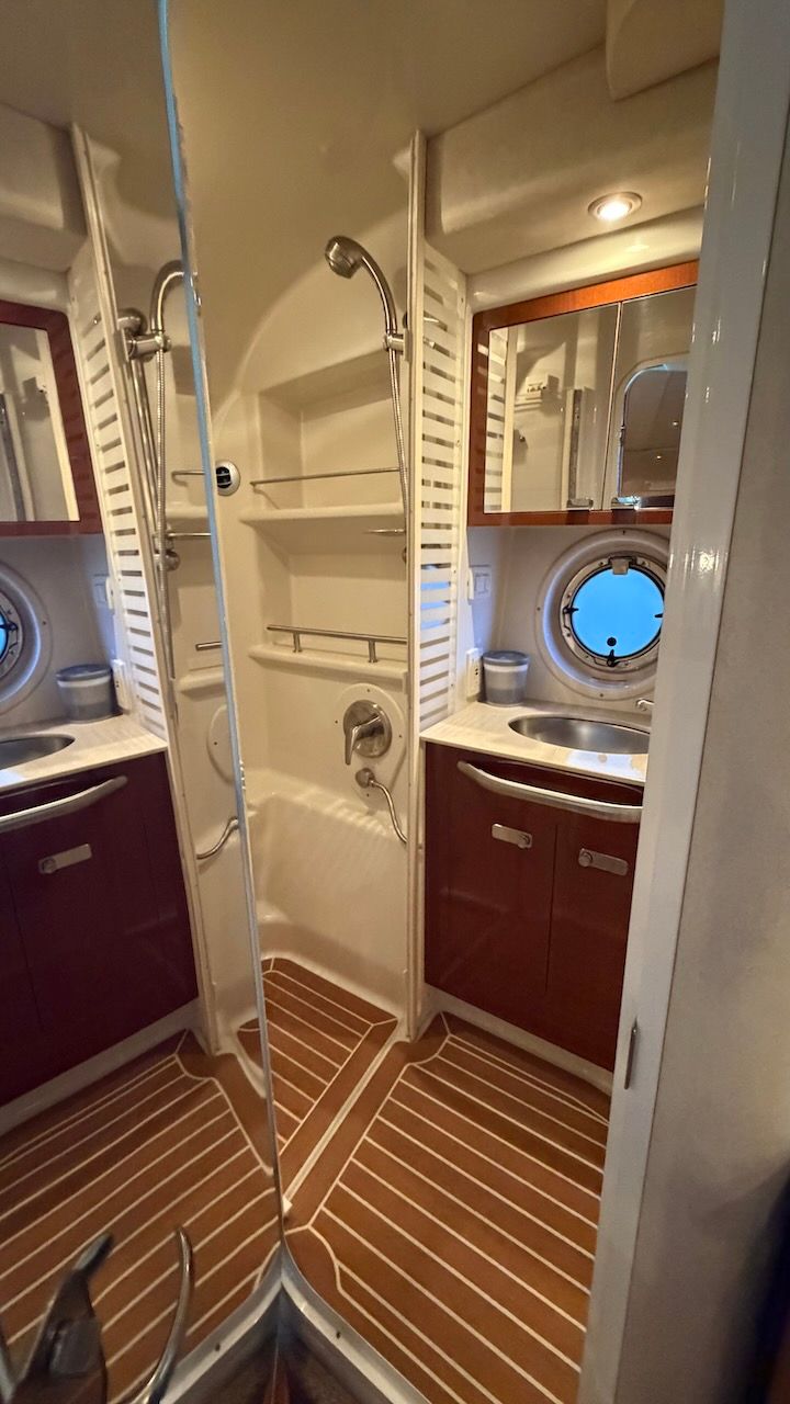 The image shows the bathroom of a 2011 Sea Ray Sundancer 370.