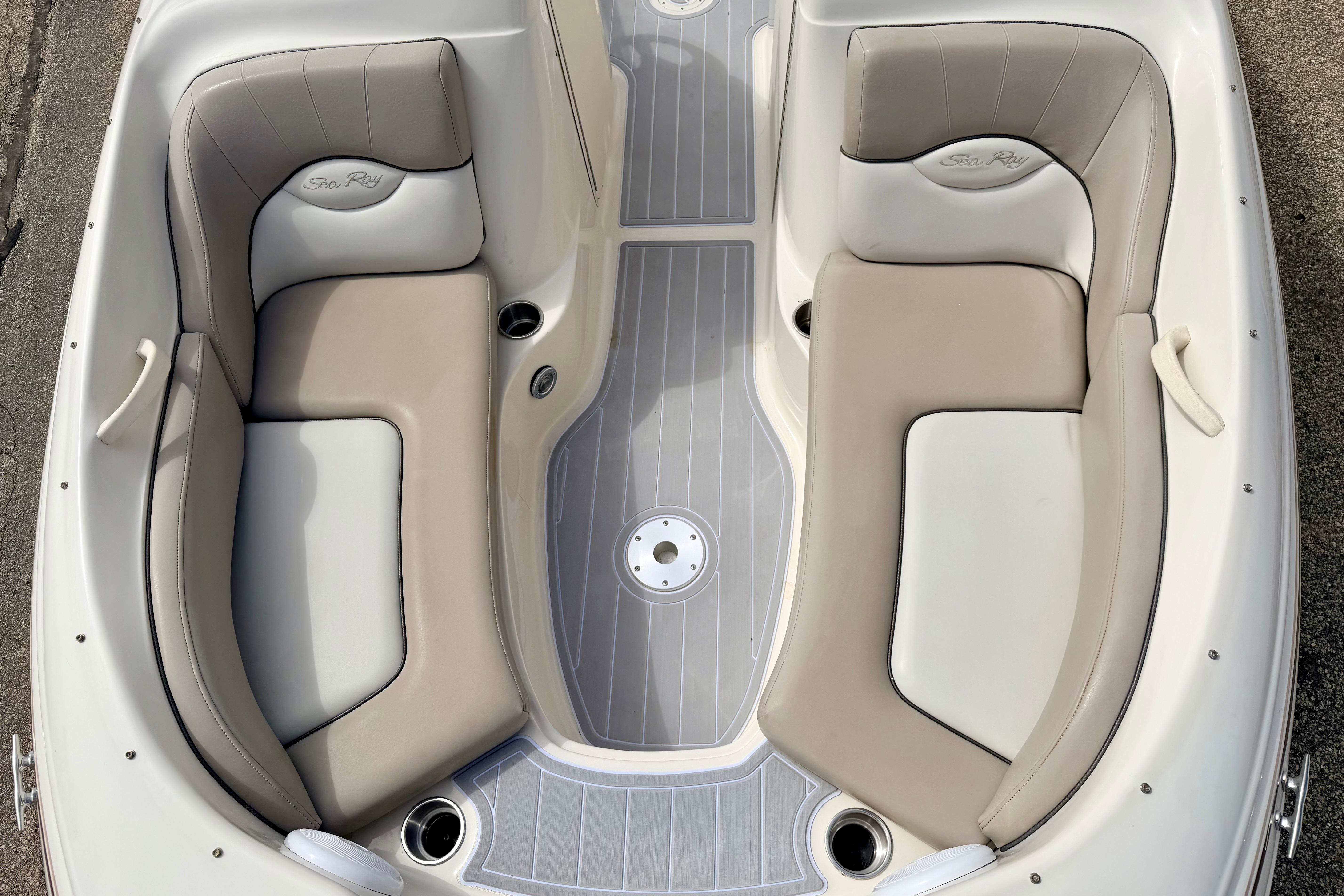 2003 Sea Ray 200 Sundeck boat interior with beige and gray seating.