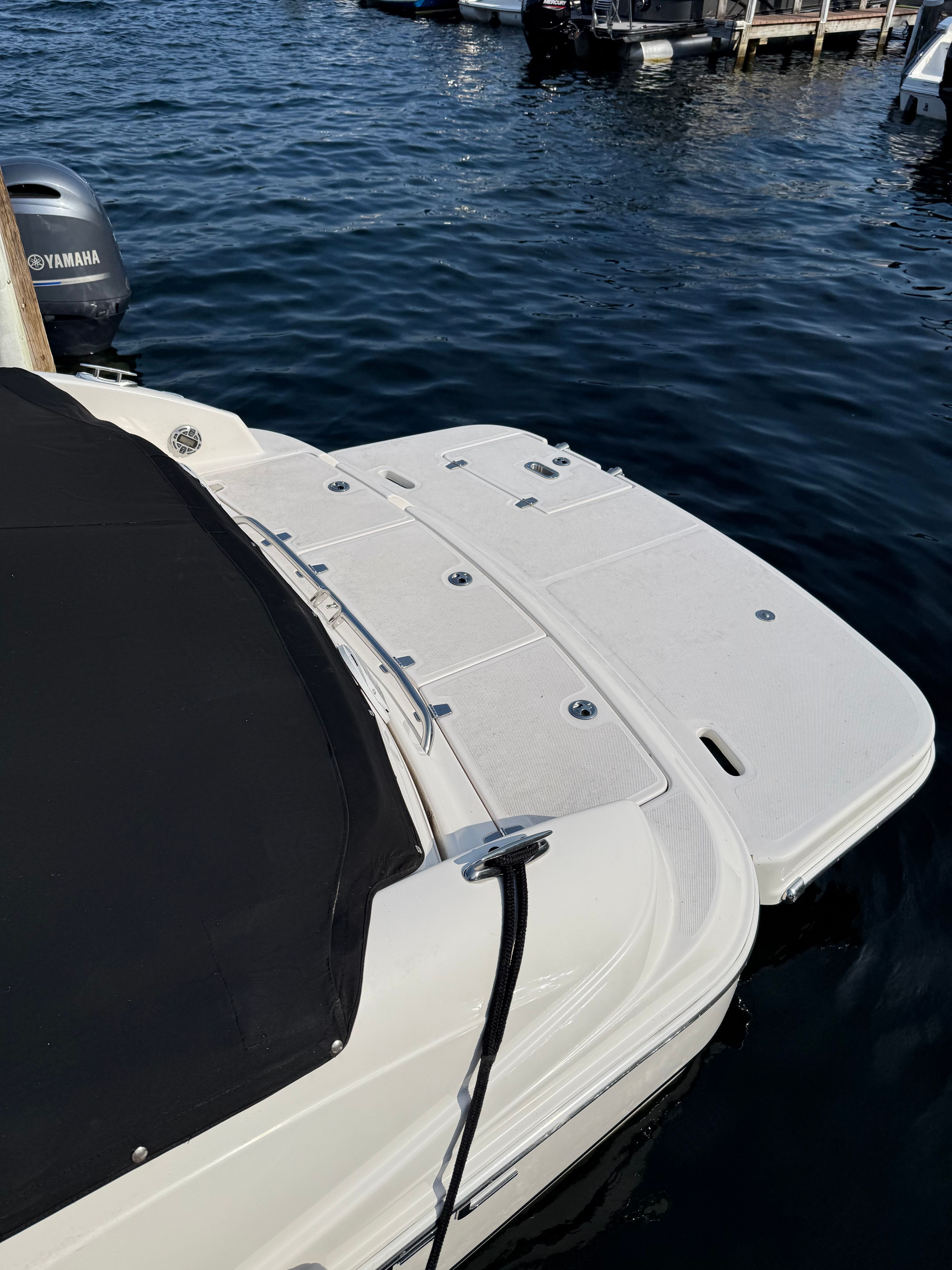 2007 Regal 2400 Bowrider boat docked, featuring a covered deck and Yamaha engine.
