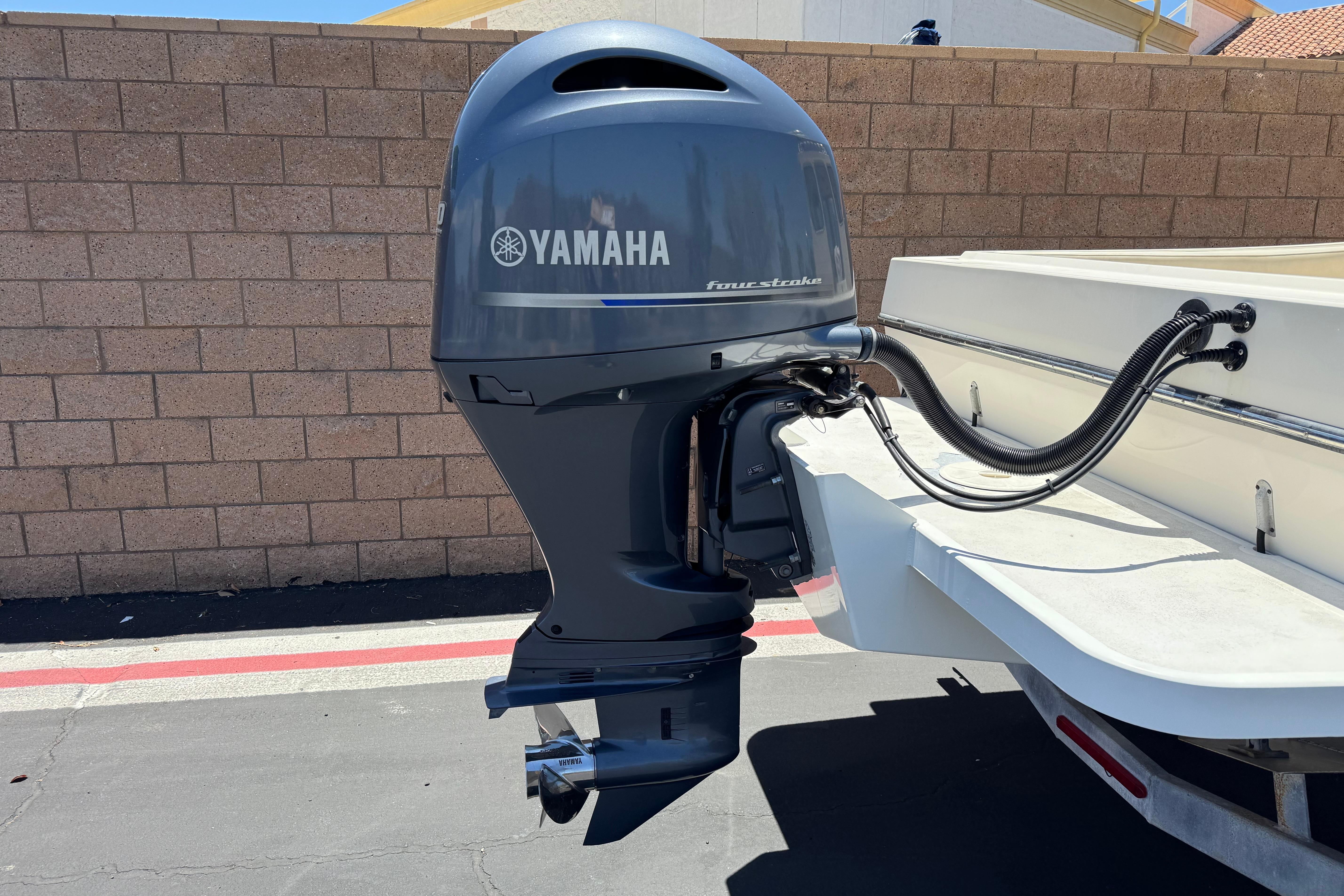2017 Defiance Admiral 220 EX with Yamaha outboard motor in a parking area.