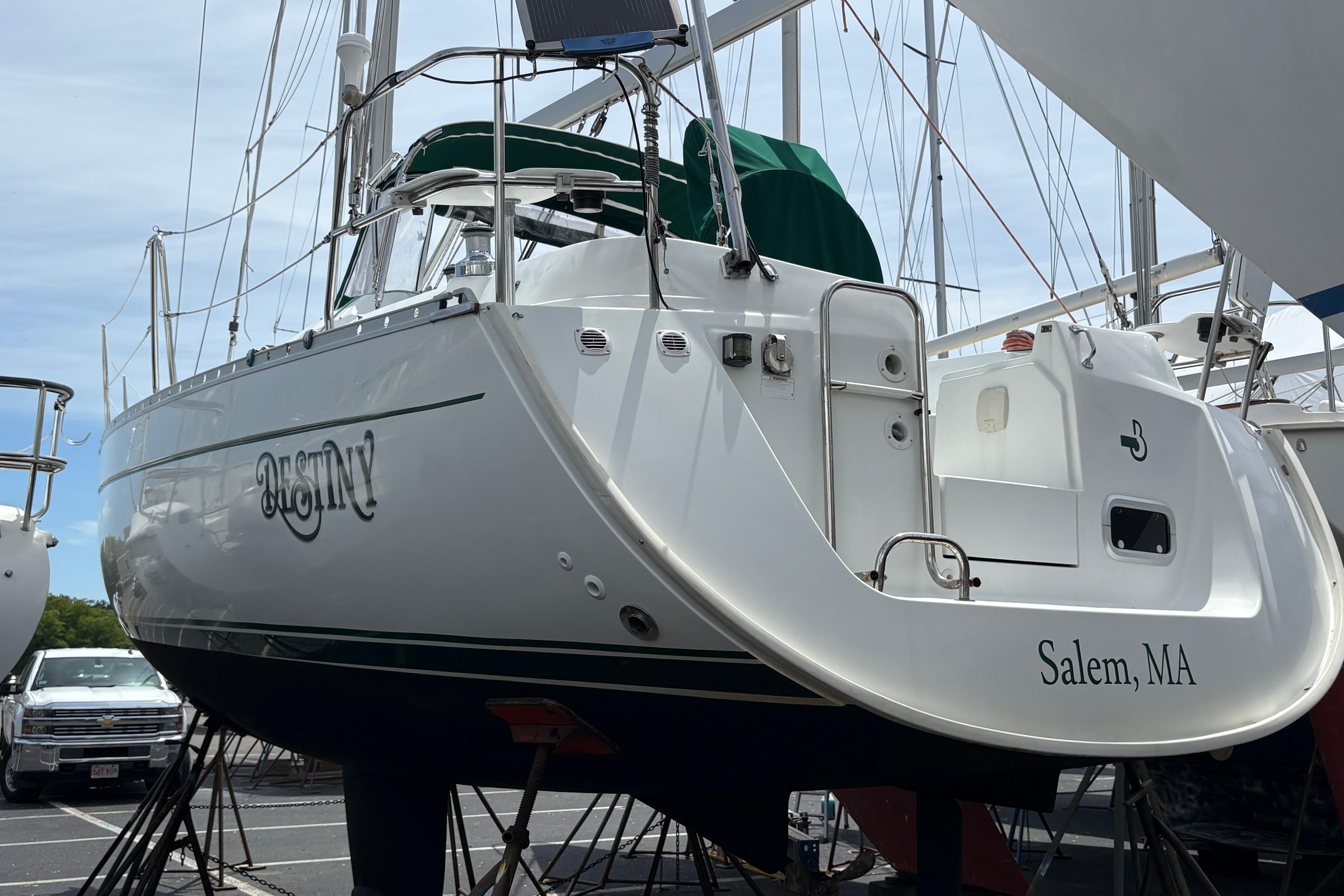 Beneteau Oceanis 321 sailboat from 2000, docked in Salem, MA, with green canopy.