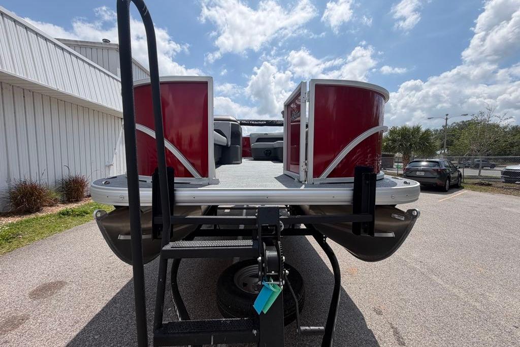 2026 Sun Tracker Party Barge 18 DLX pontoon boat on trailer, sunny day.