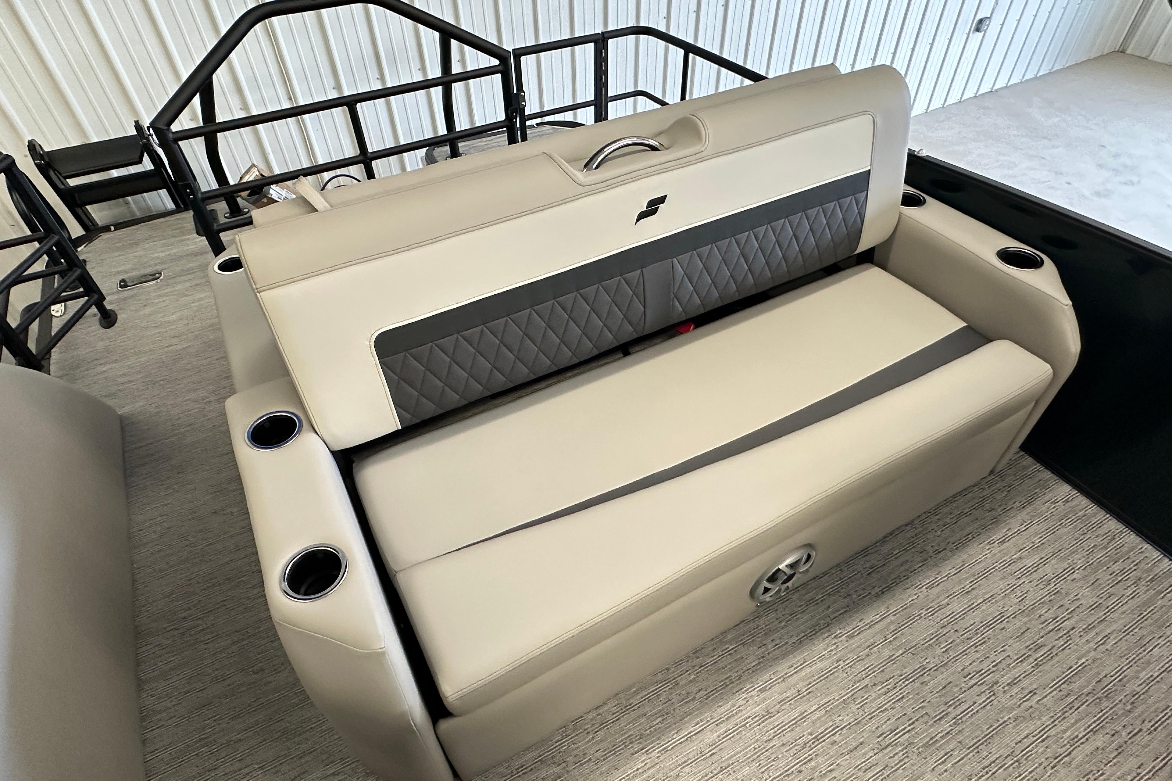 2026 Starcraft SLS 3 Q DH boat interior with beige seating and cup holders.