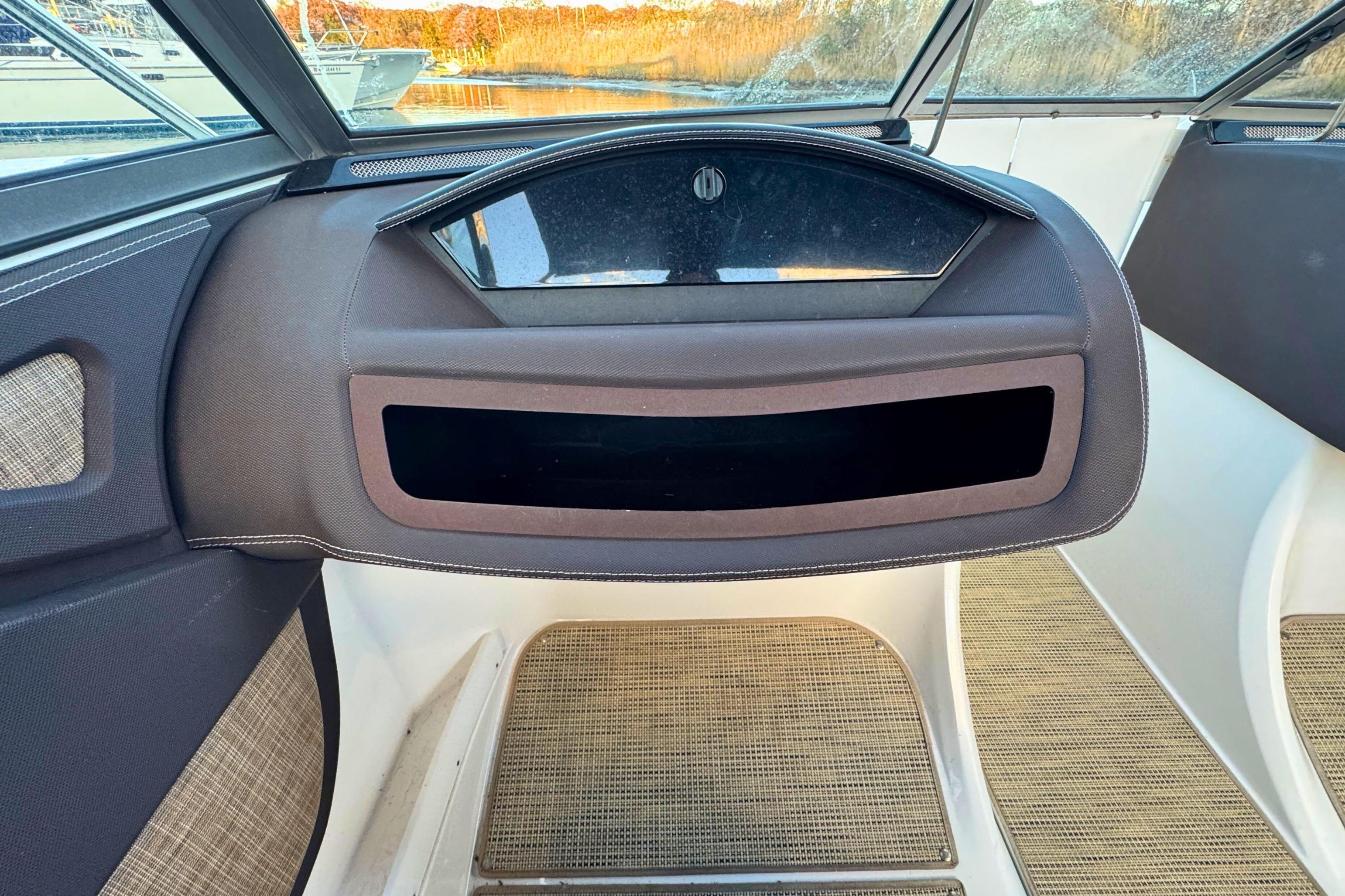 2019 Cobalt R3 boat interior with dashboard and open storage compartment.