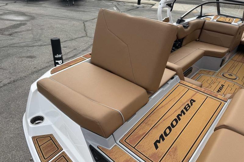 2026 Moomba Max boat interior with tan seating and branded flooring.