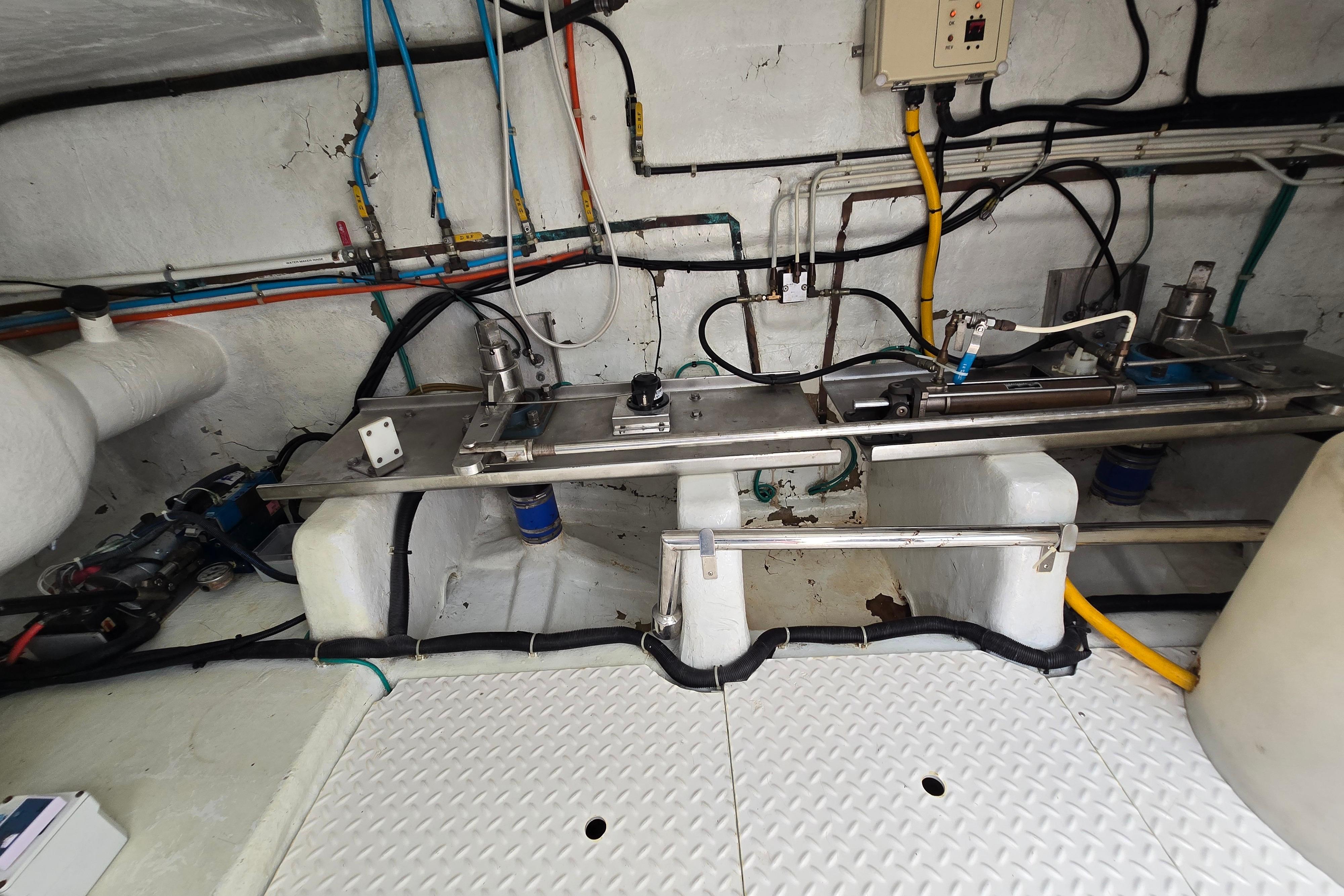 Engine room of a 2004 Grand Harbour 58 yacht, showcasing pipes and machinery.