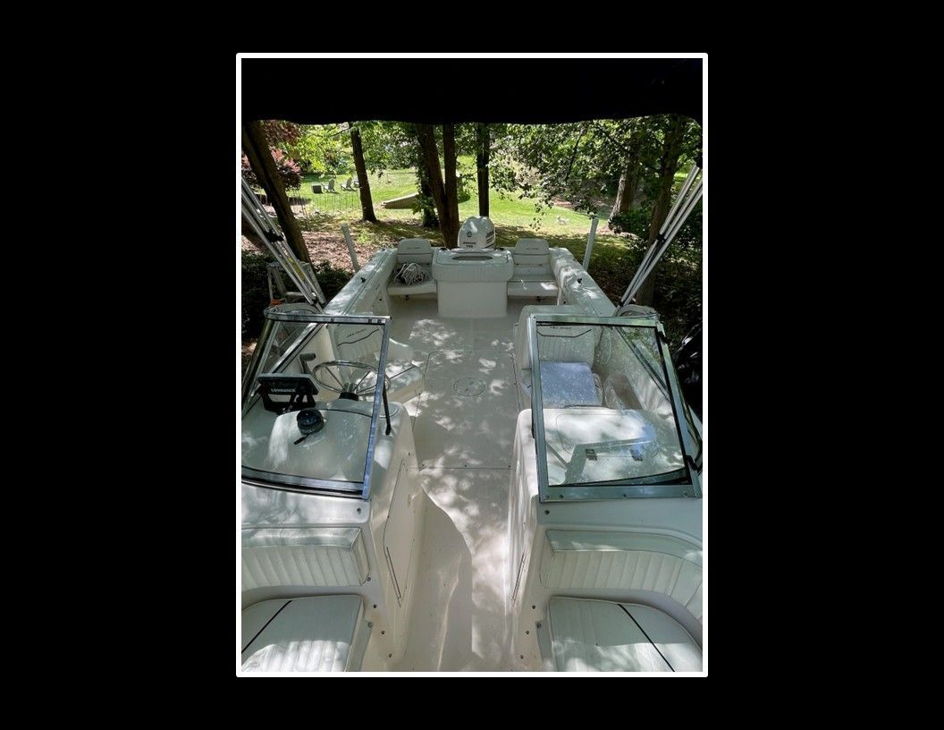 Interior view of a 2004 Sea Hunt Escape boat with seating and helm console.