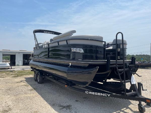 2023 Regency 250 LE3 pontoon boat on trailer, parked outdoors.