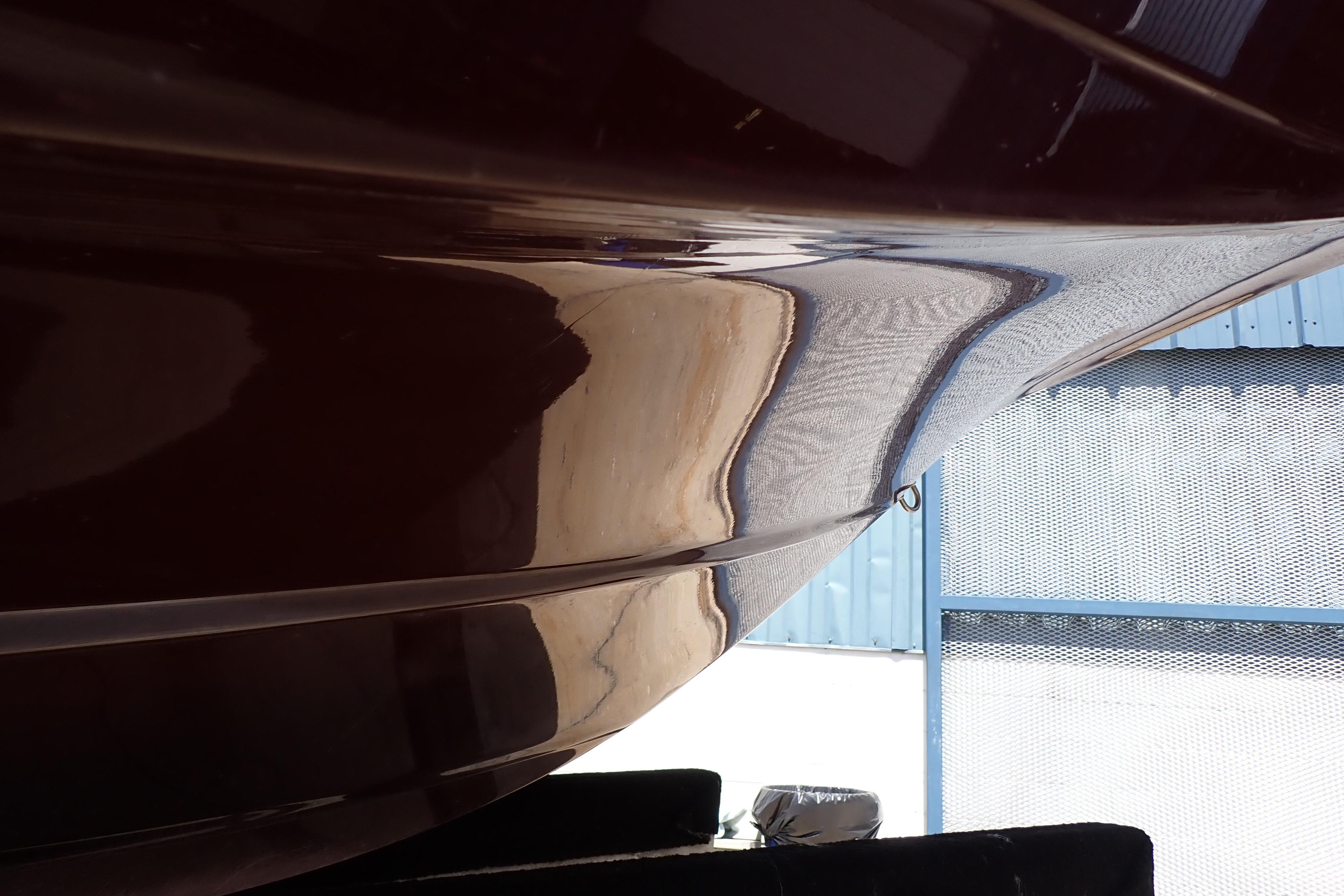 Close-up of 2021 Hurricane SunDeck Sport 185 OB boat hull in sunlight.