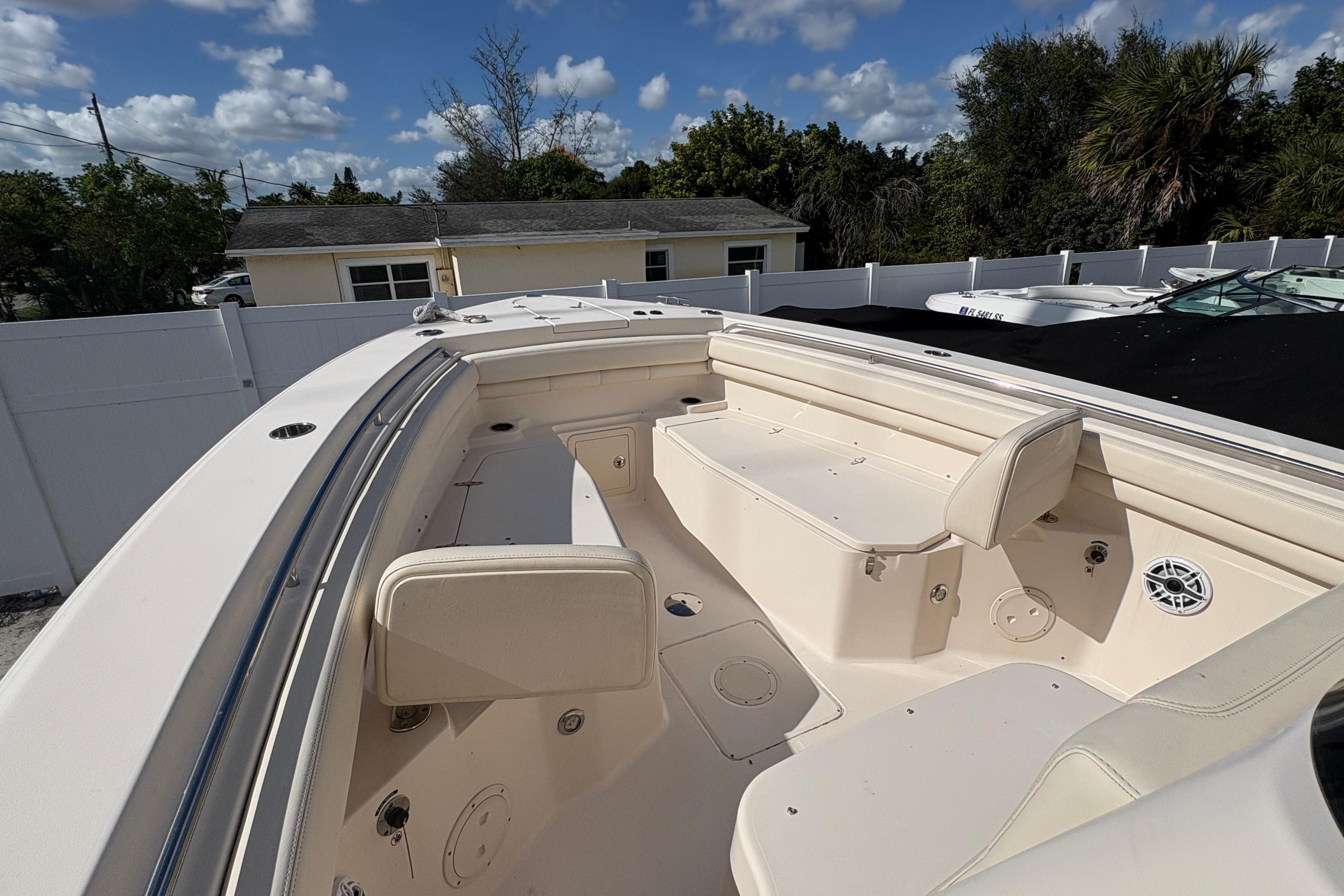 2018 Grady-White Canyon 306 boat interior with seating and storage, under a clear blue sky.