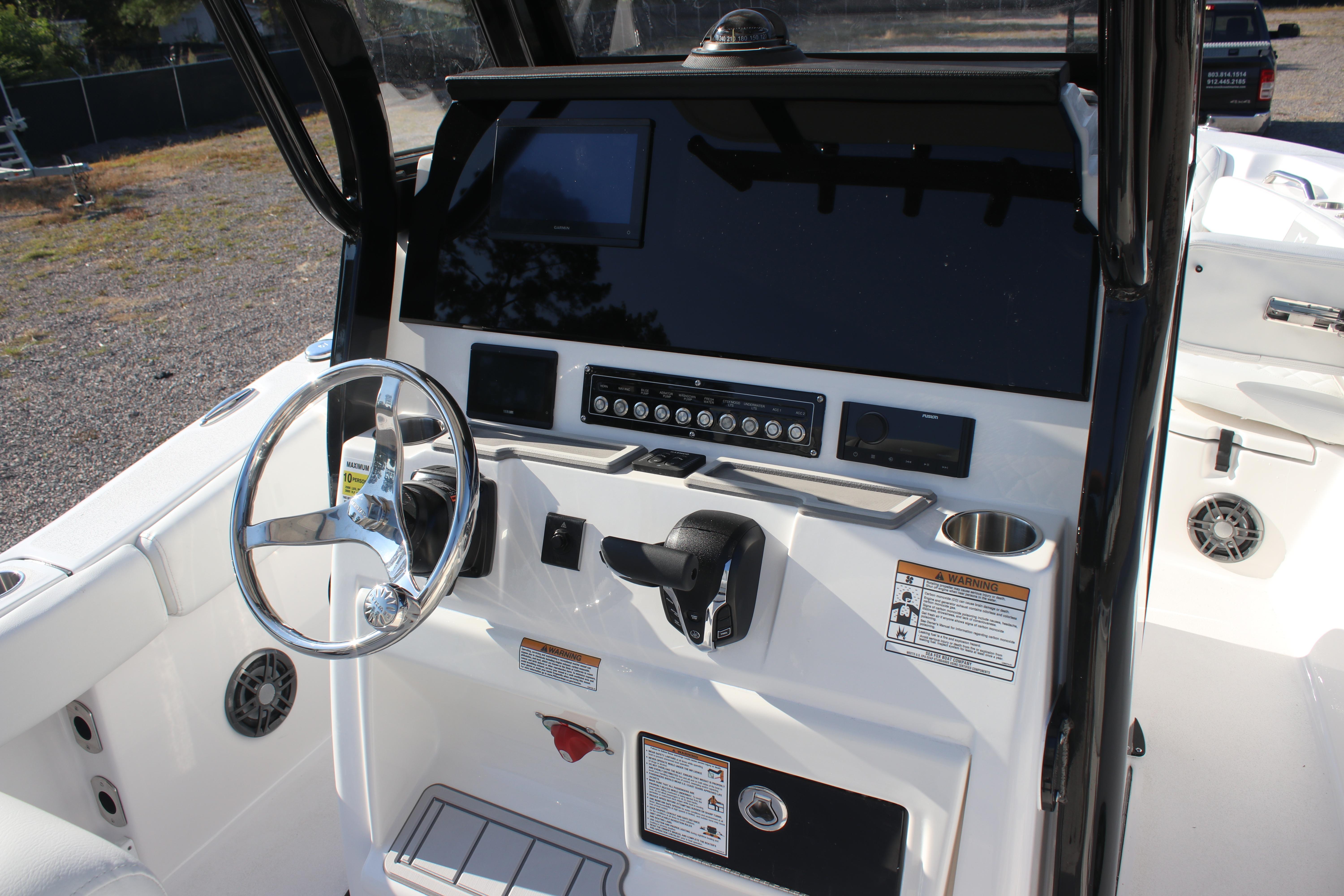 2026 Sea Fox 248 Commander boat dashboard with steering wheel and control panel.